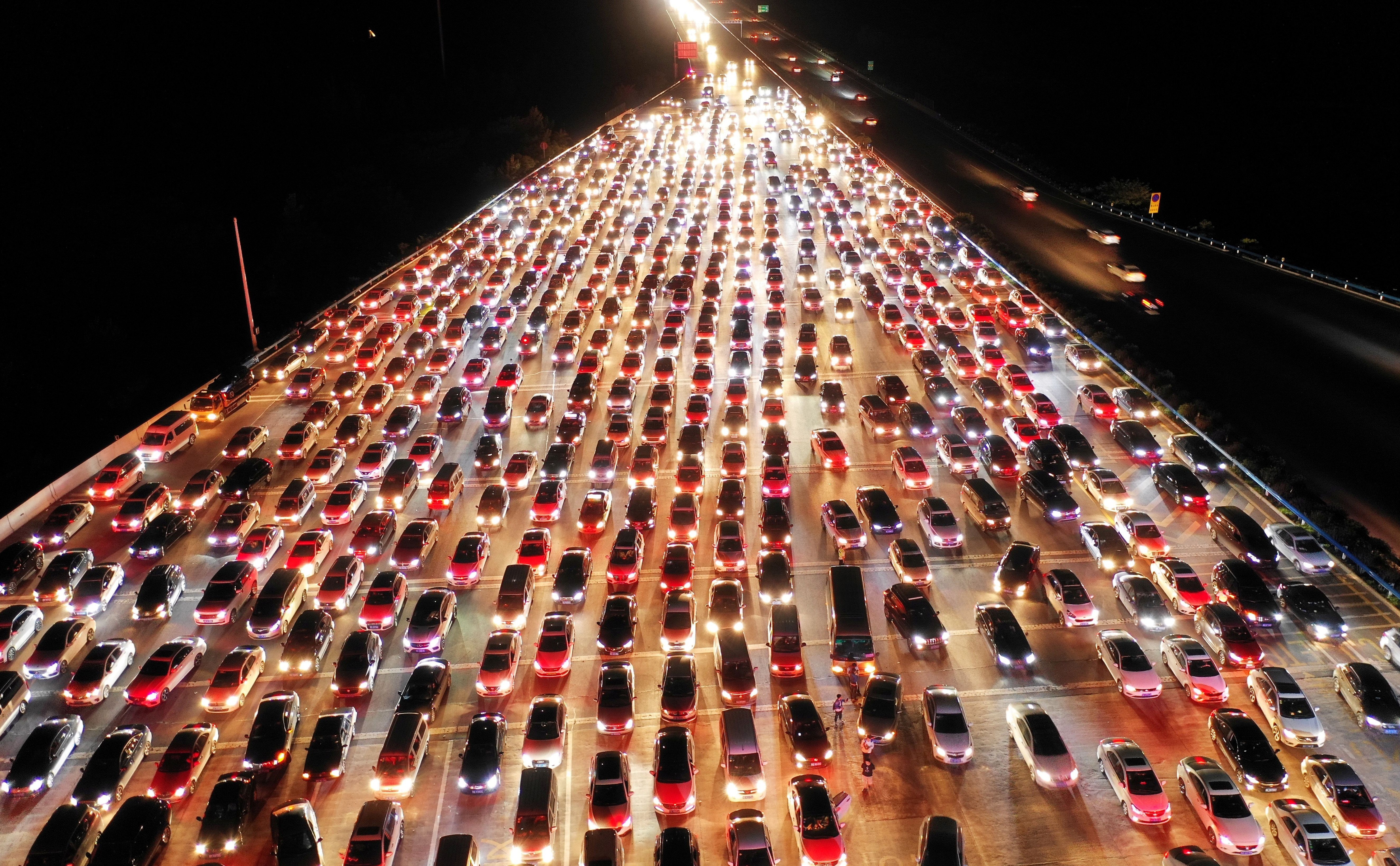 Vehicles are seen jammed on a express way near a toll station, at the end of the Mid-Autumn Festival holiday, in Zhengzhou, Henan