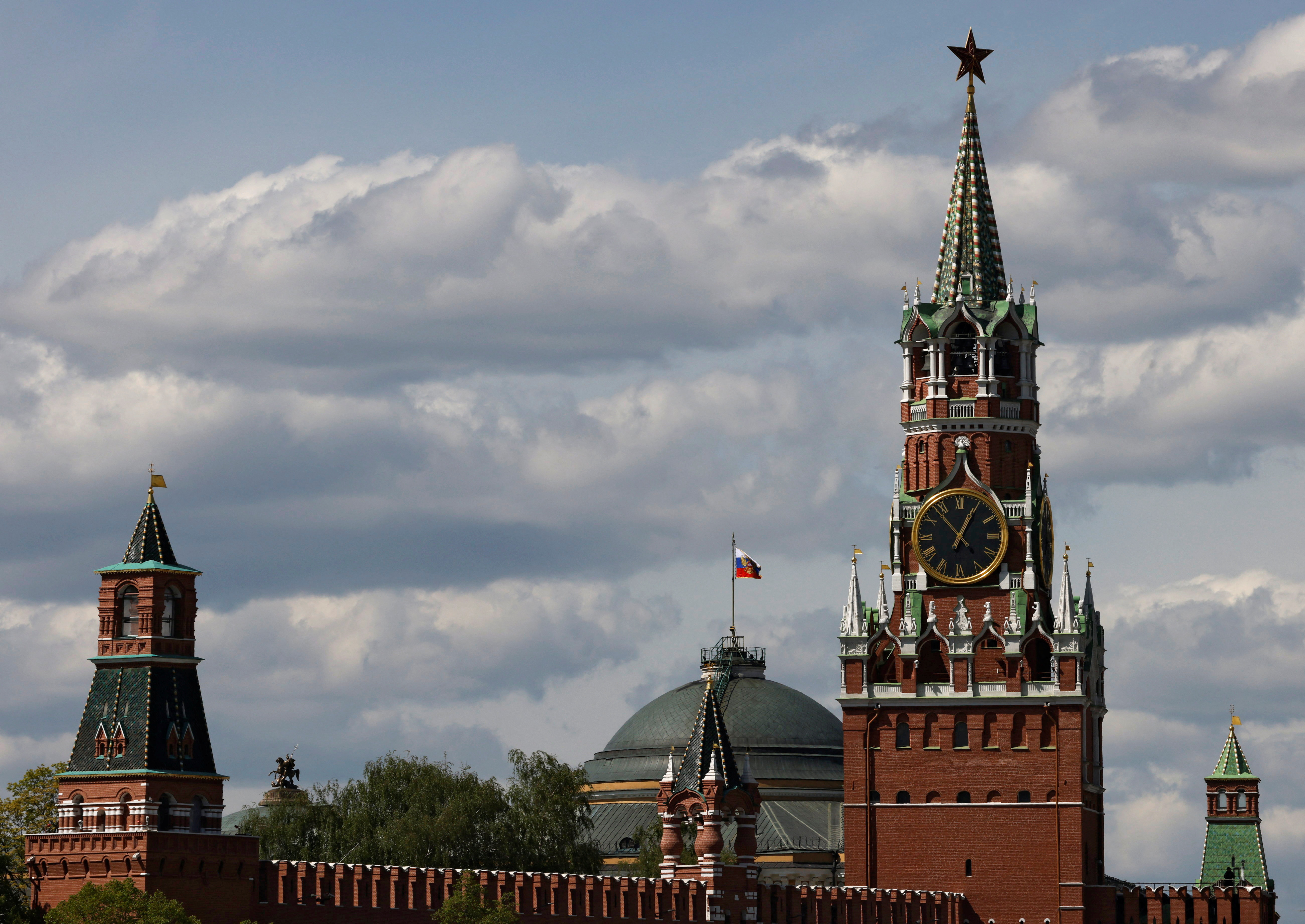 The Russian flag flies on the dome of the Kremlin Senate building in Moscow