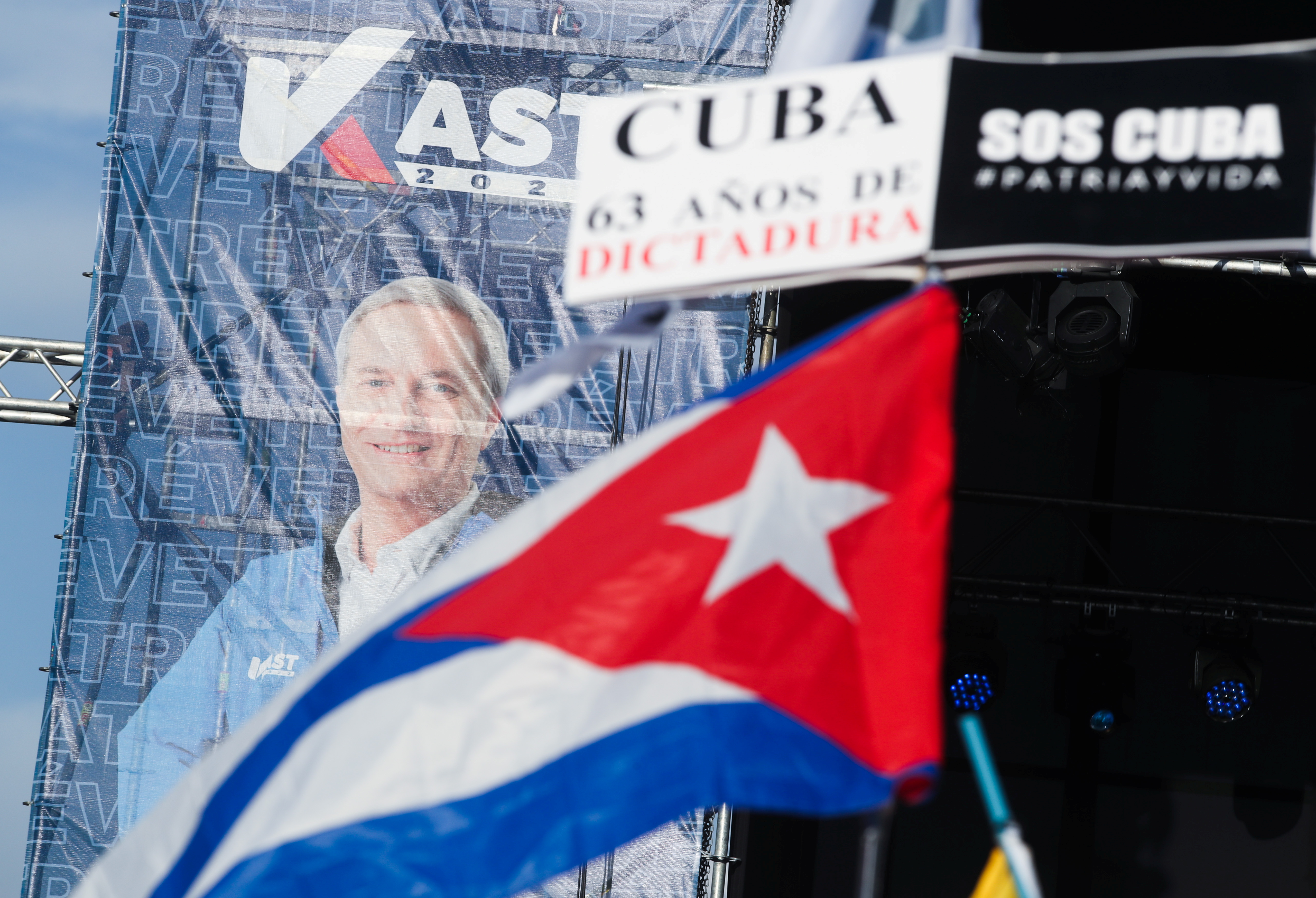 Supporters of Chilean presidential candidate Jose Antonio Kast wave a Cuban flag and sign during his closing campaign rally in Santiago, Chile, November 18, 2021. The sign reads as 