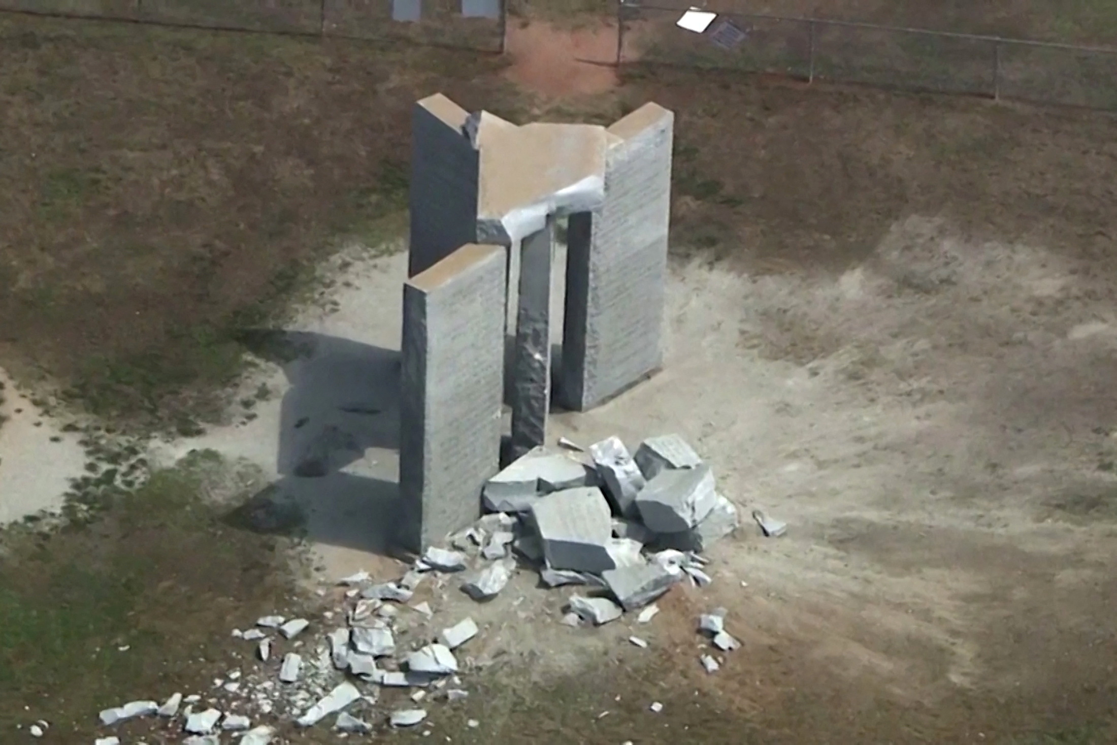 Rubble is cast around the Georgia Guidestones after an explosion in Elberton