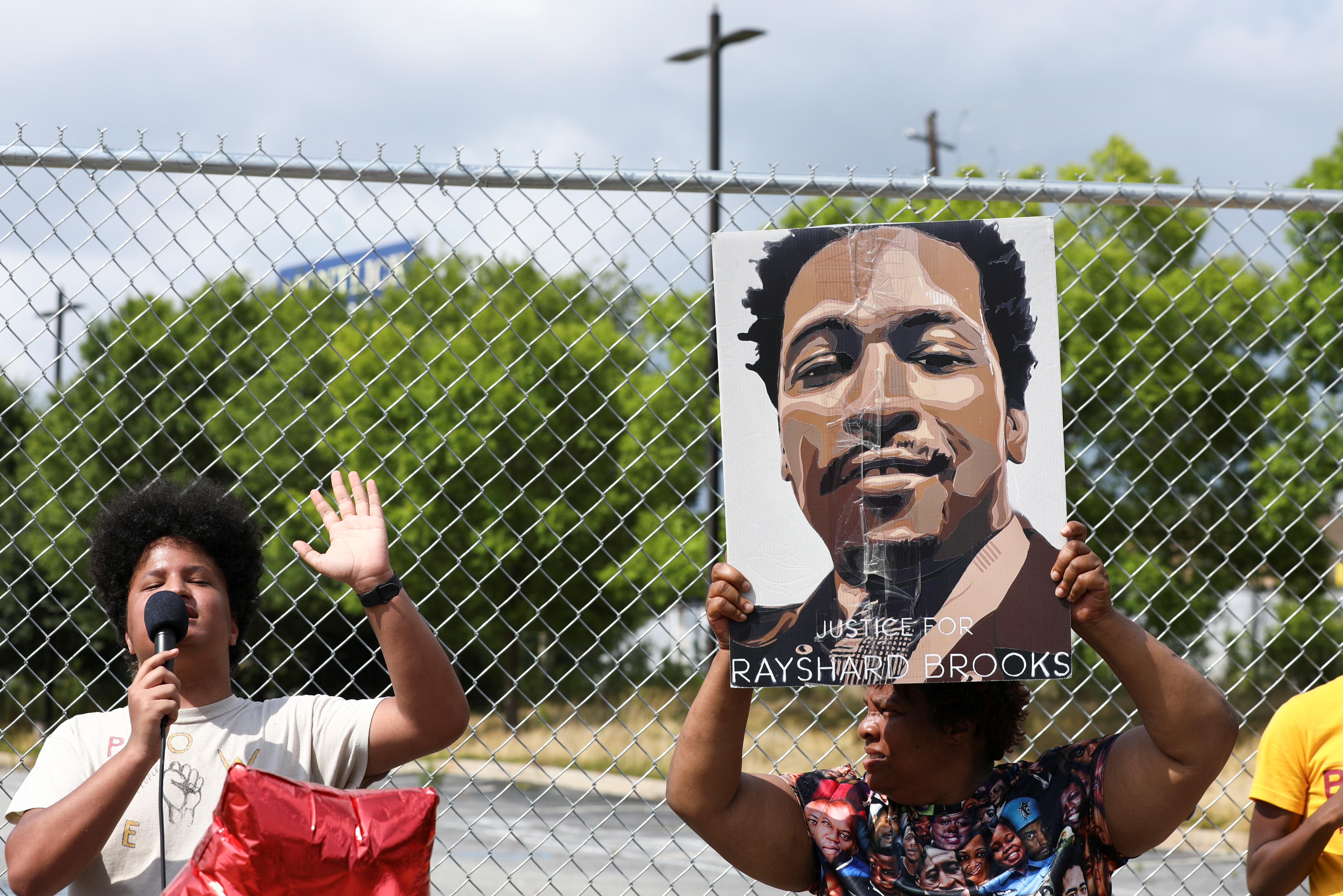 People attend a rally for racial justice on the one year anniversary of the police shooting of Rayshard Brooks, in Atlanta