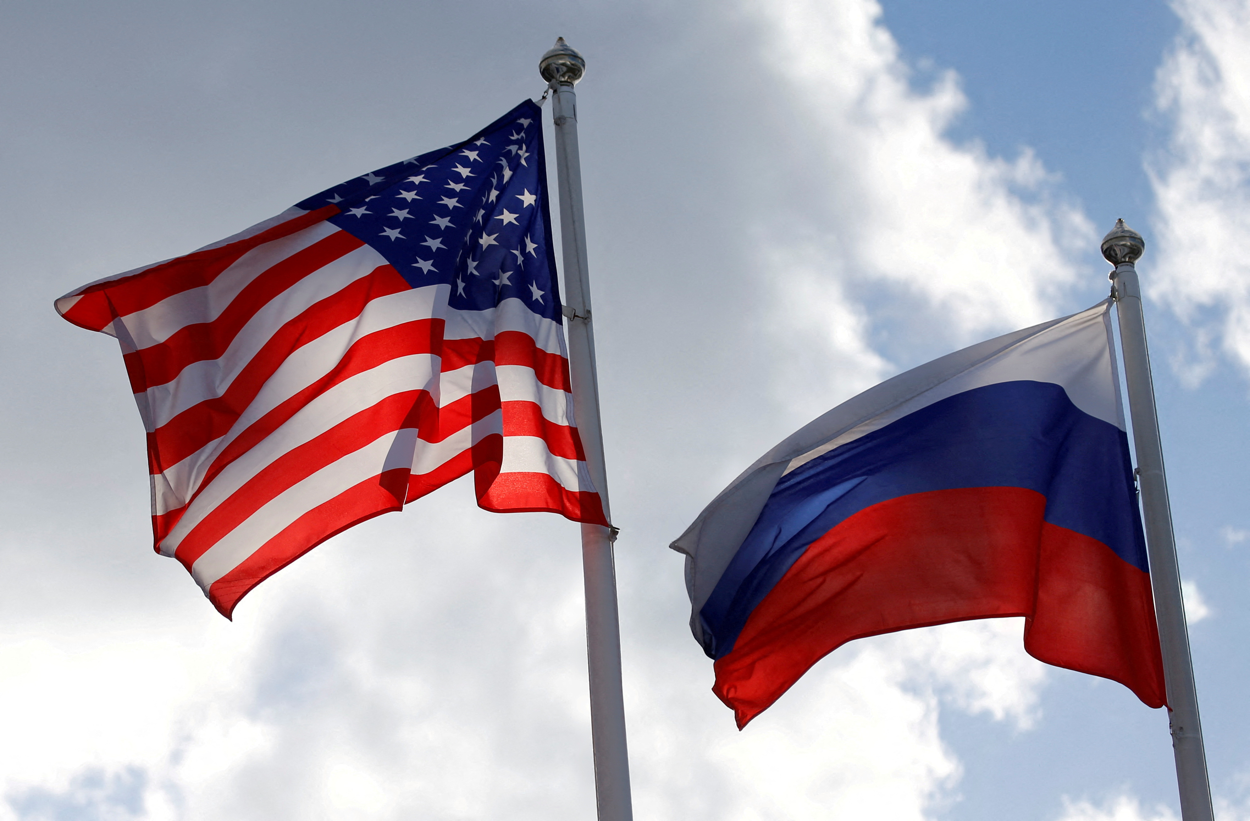 Russian and U.S. state flags fly near a factory in Vsevolozhsk
