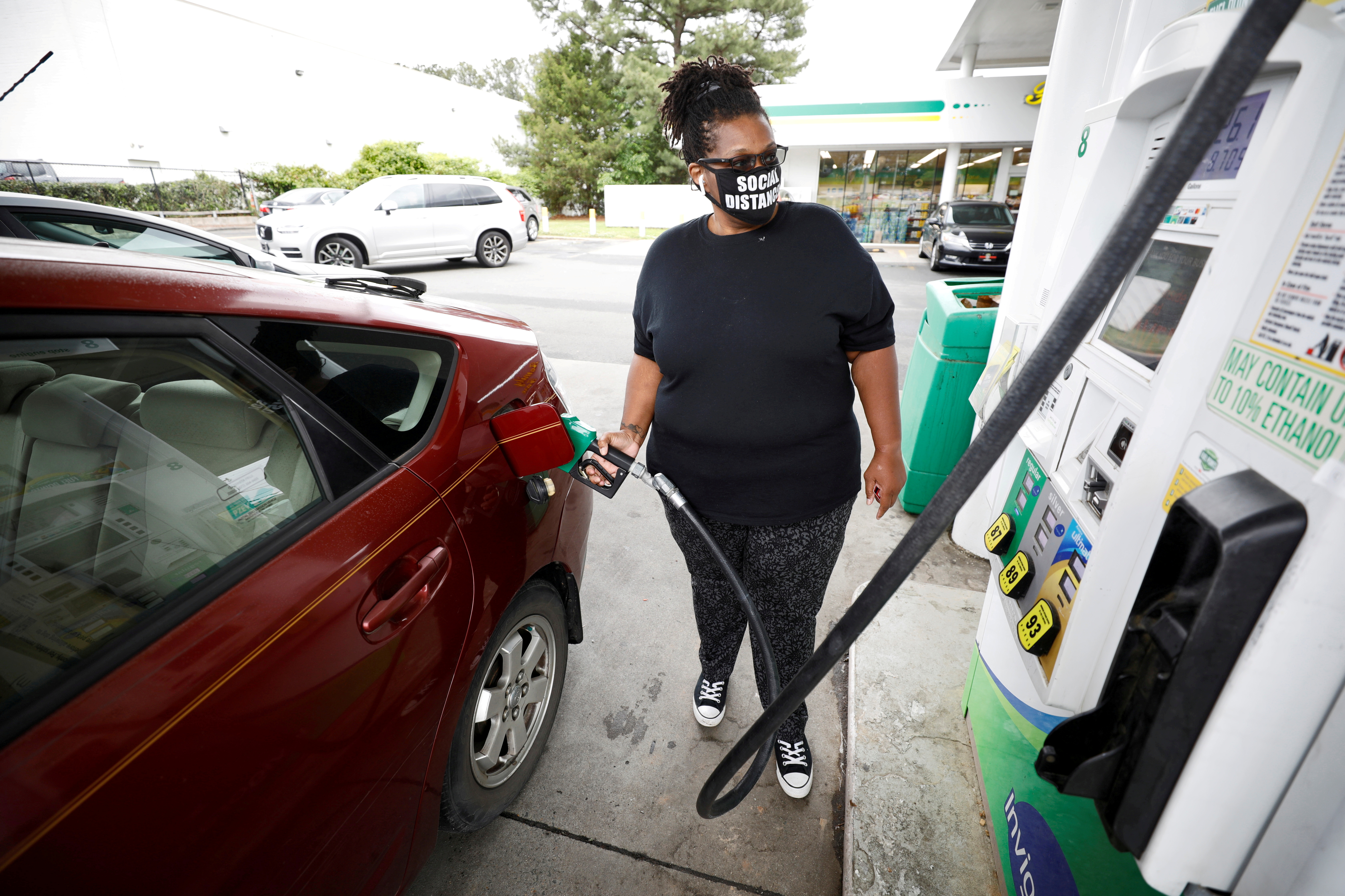 Motorist fills up at gasoline station during surge in demand in Durham, North Carolina