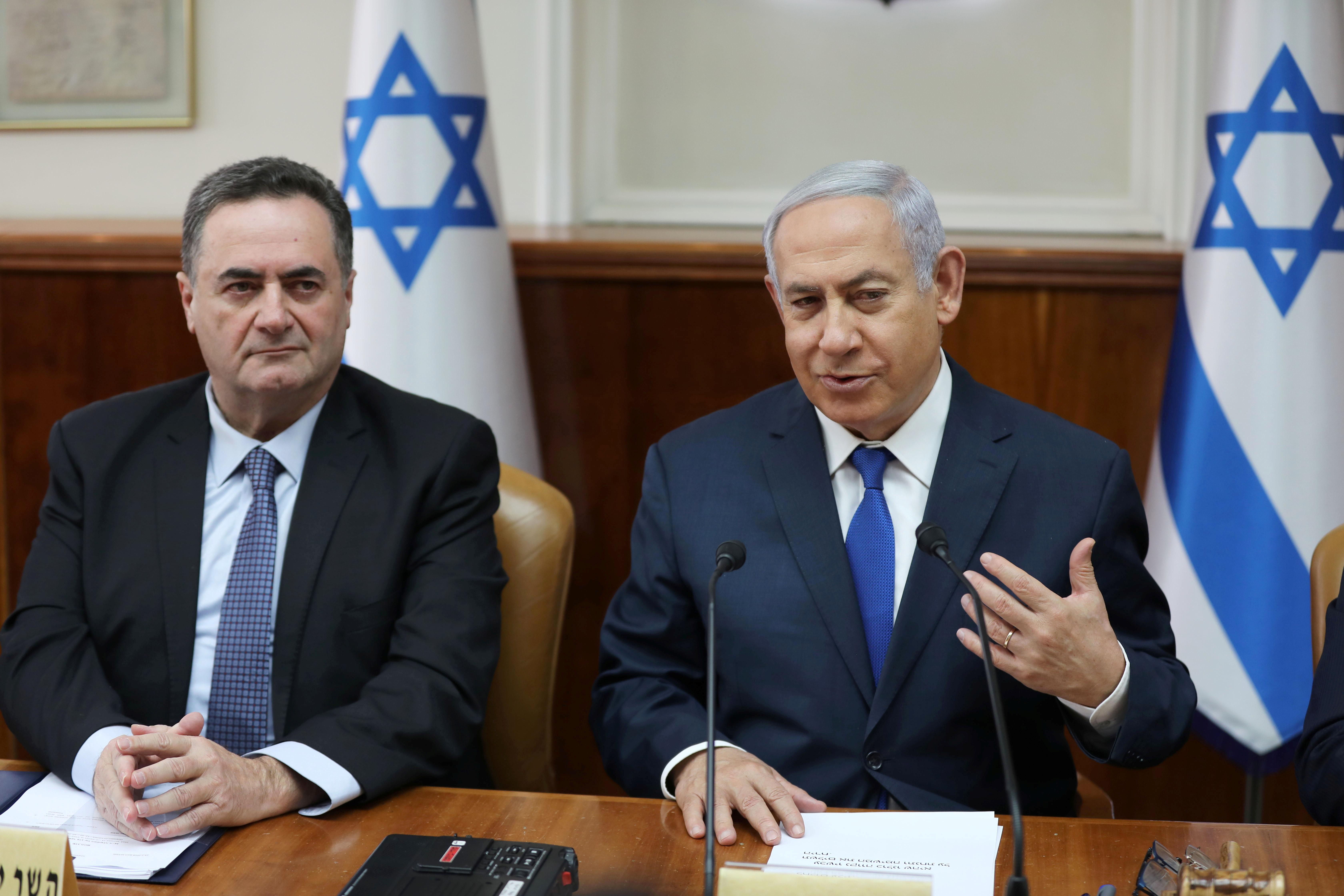 Israeli Prime Minister Benjamin Netanyahu sits next to acting foreign minister Israel Katz, who also serves as intelligence and transport minister, during the weekly cabinet meeting in Jerusalem