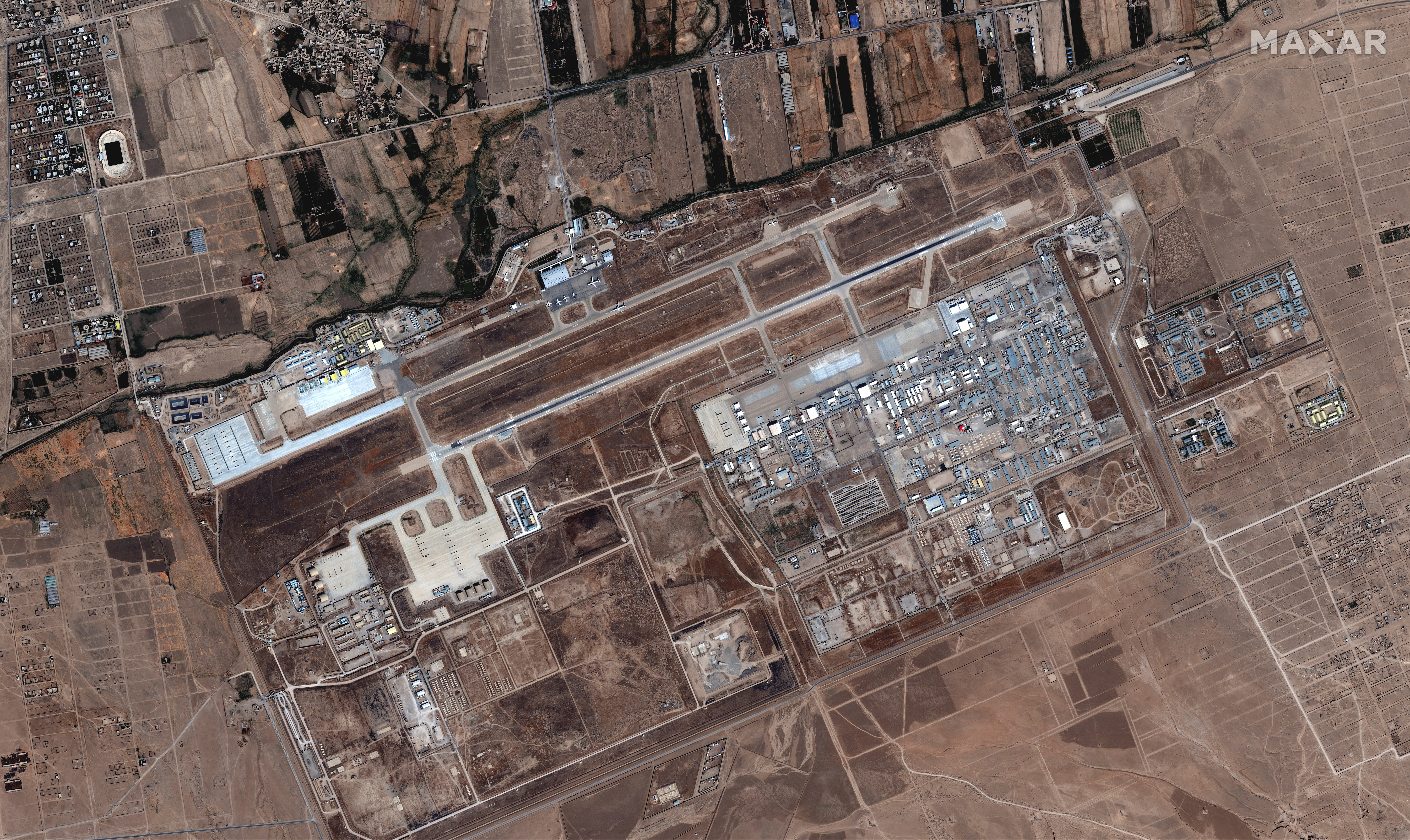 Six commercial airplanes are seen near the main terminal of the Mazar-i-Sharif airport