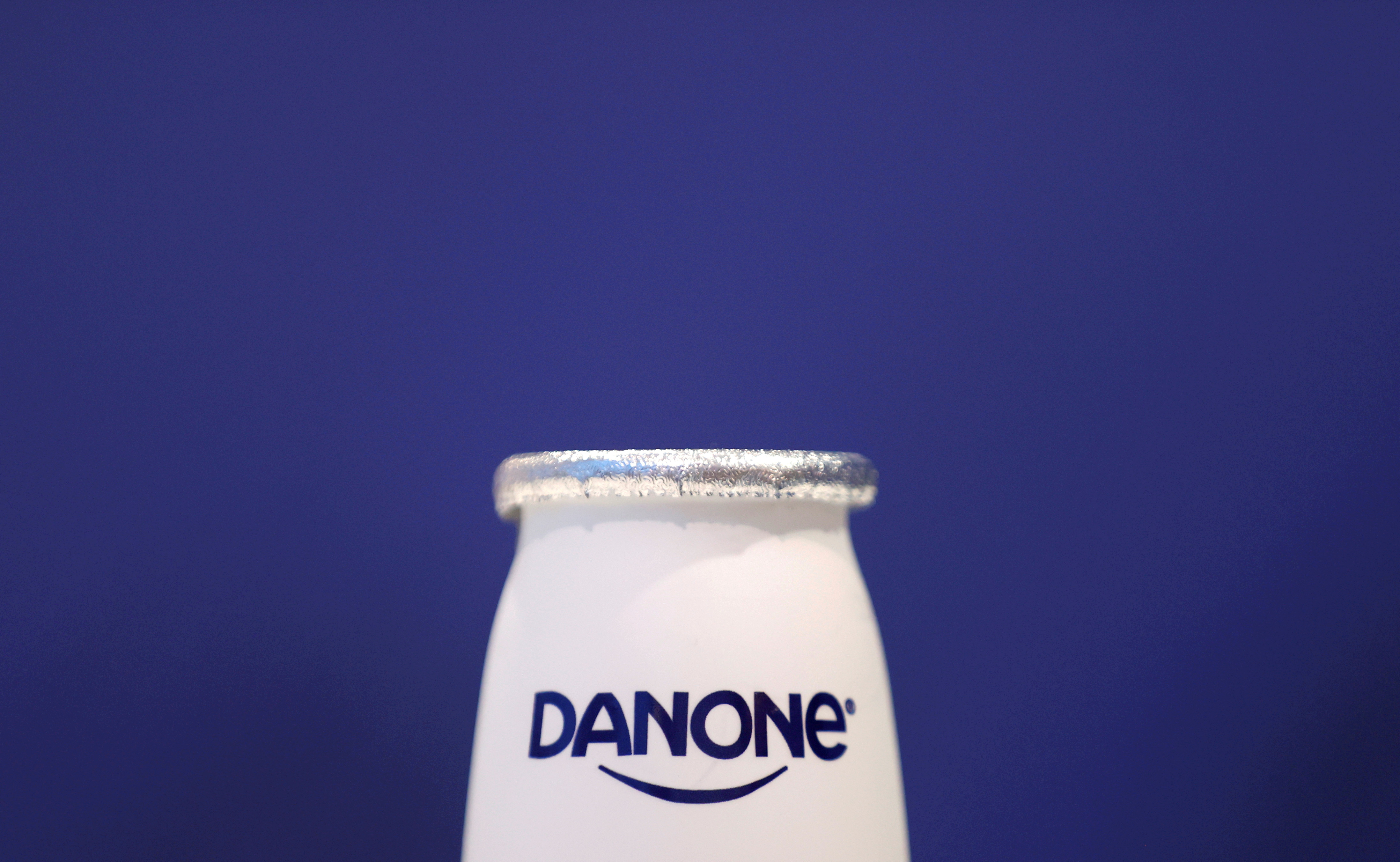 A company logo is seen on a product displayed before French food group Danone's 2019 annual results presentation in Paris, France, February 26, 2020. REUTERS/Christian Hartmann/File Photo