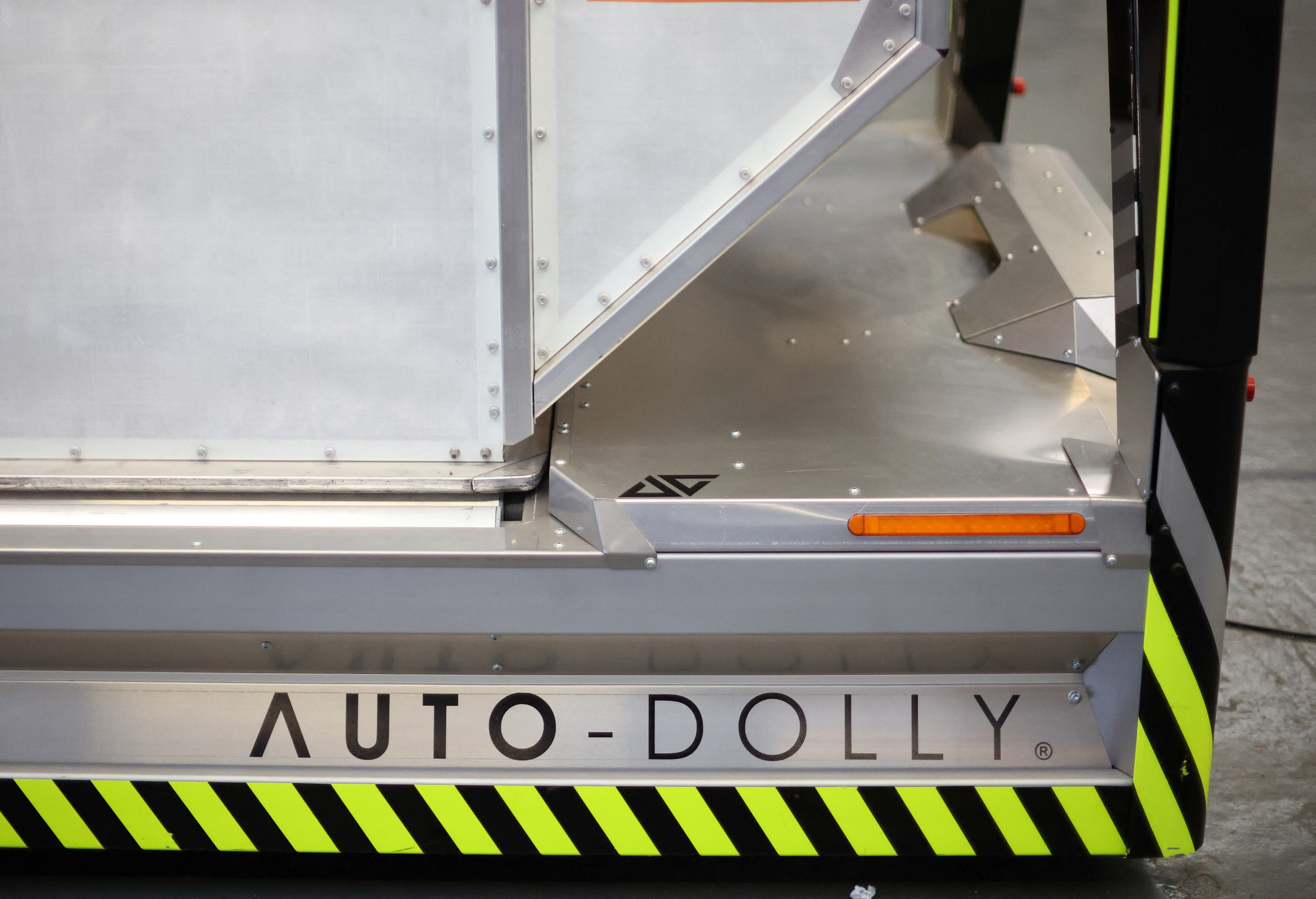 A baggage holder sits on top of one of the company's autonomous 'Auto-Dolly' baggage transporter at the Aurrigo factory in Coventry