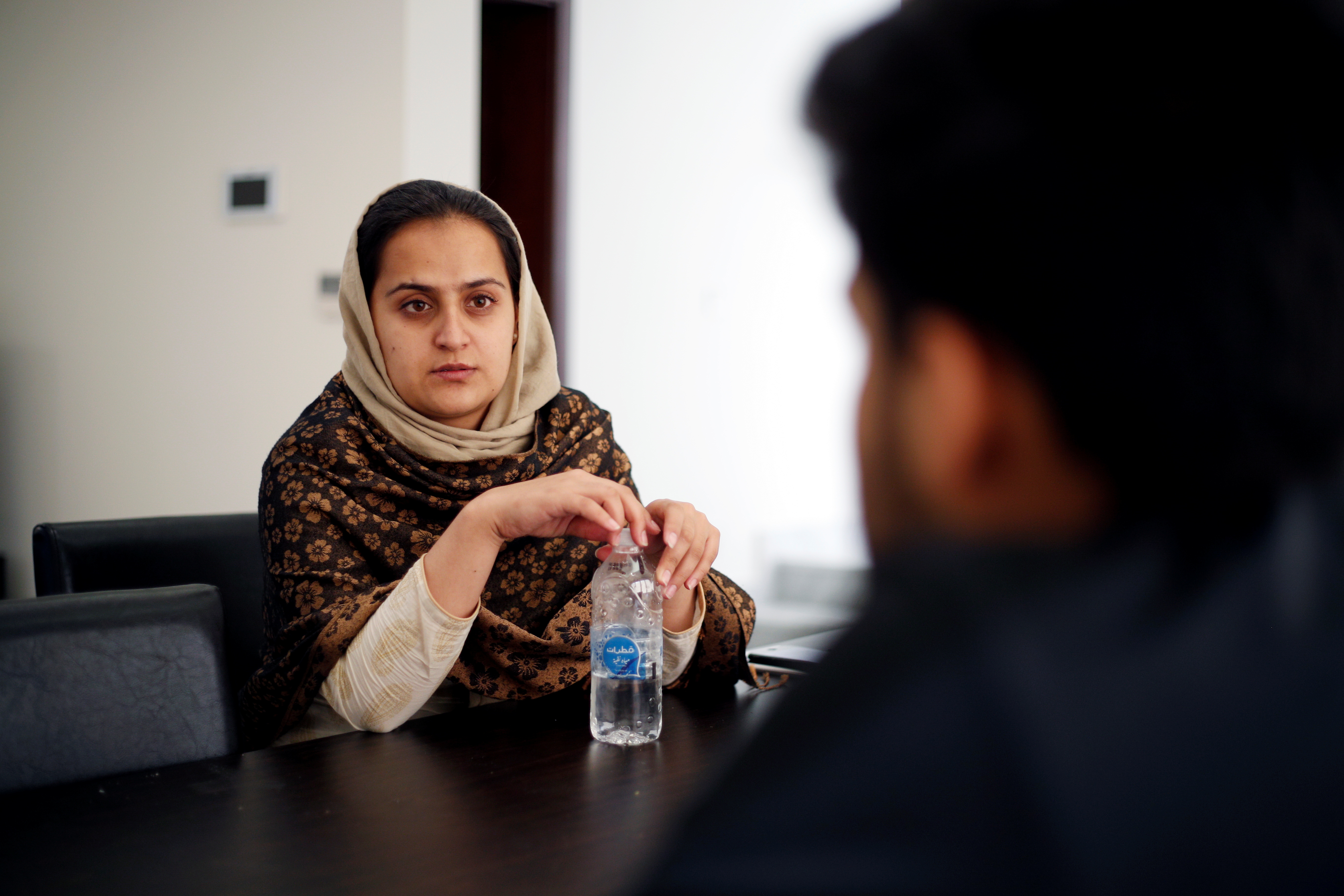 Afghan news anchor Beheshta Arghand speaks to her brother at a temporary residence compound in Doha