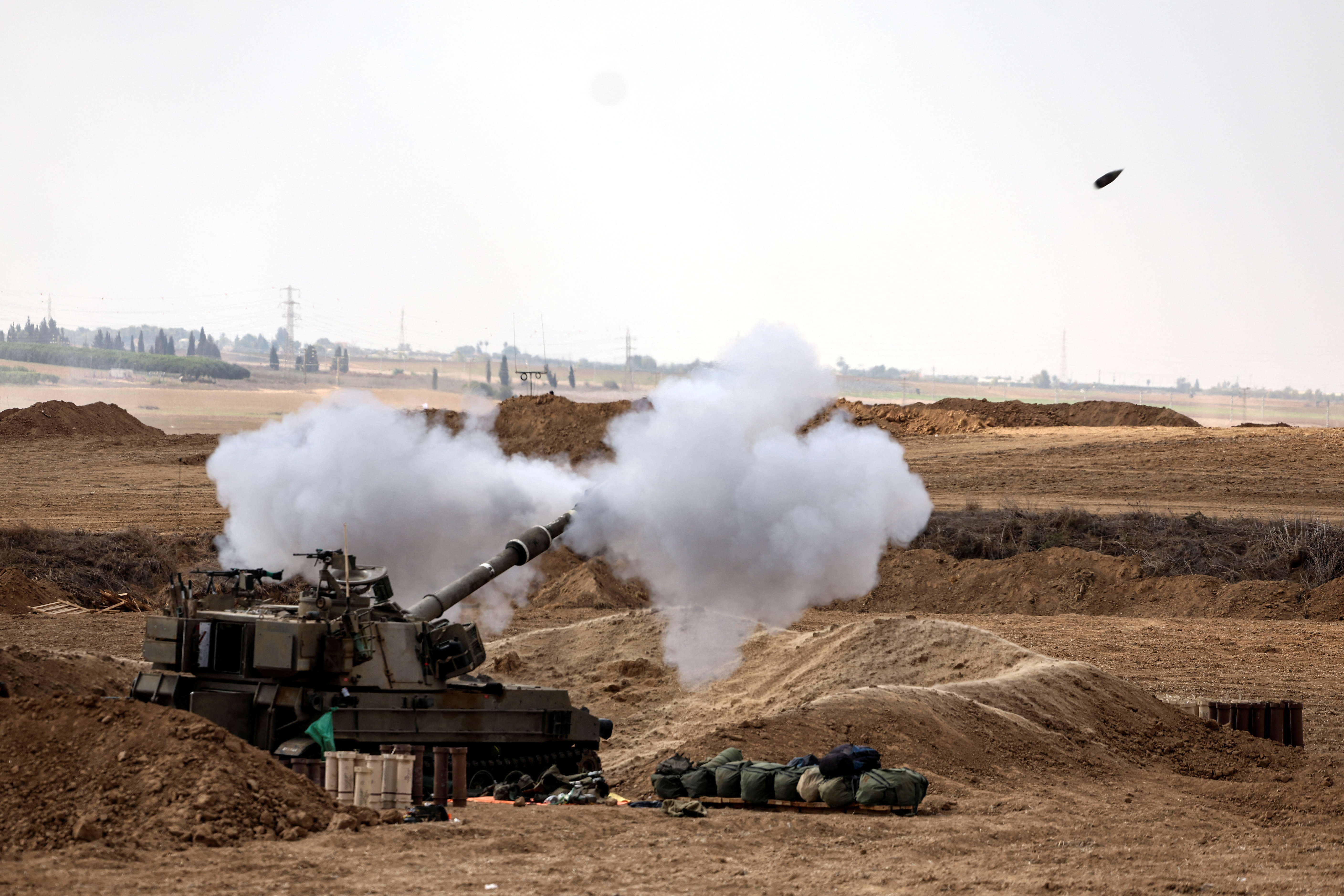 An Israeli tank fires near Israel's border with the Gaza Strip, in southern Israel