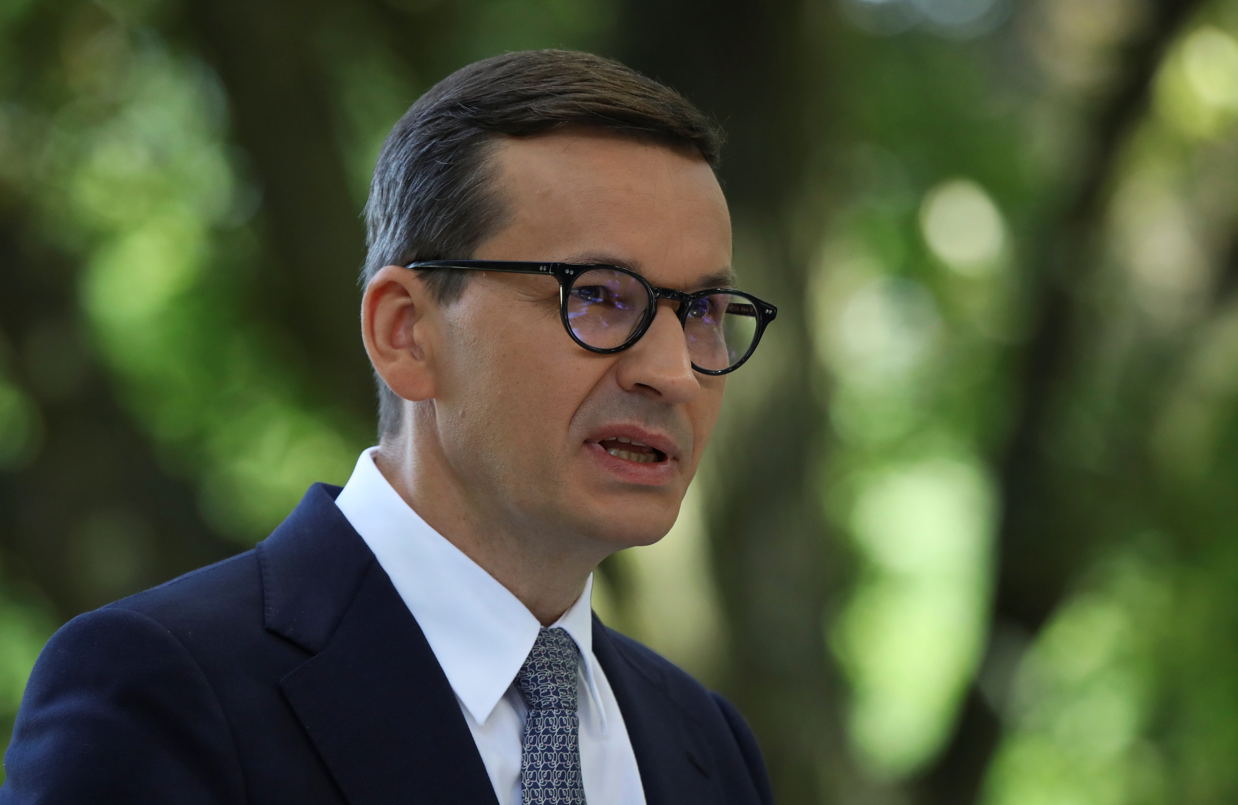 Polish Prime Minister Mateusz Morawiecki speaks during news conference with German Chancellor Angela Merkel after their meeting in Royal Lazienki Park in Warsaw, Poland, September 11, 2021. REUTERS/Kacper Pempel