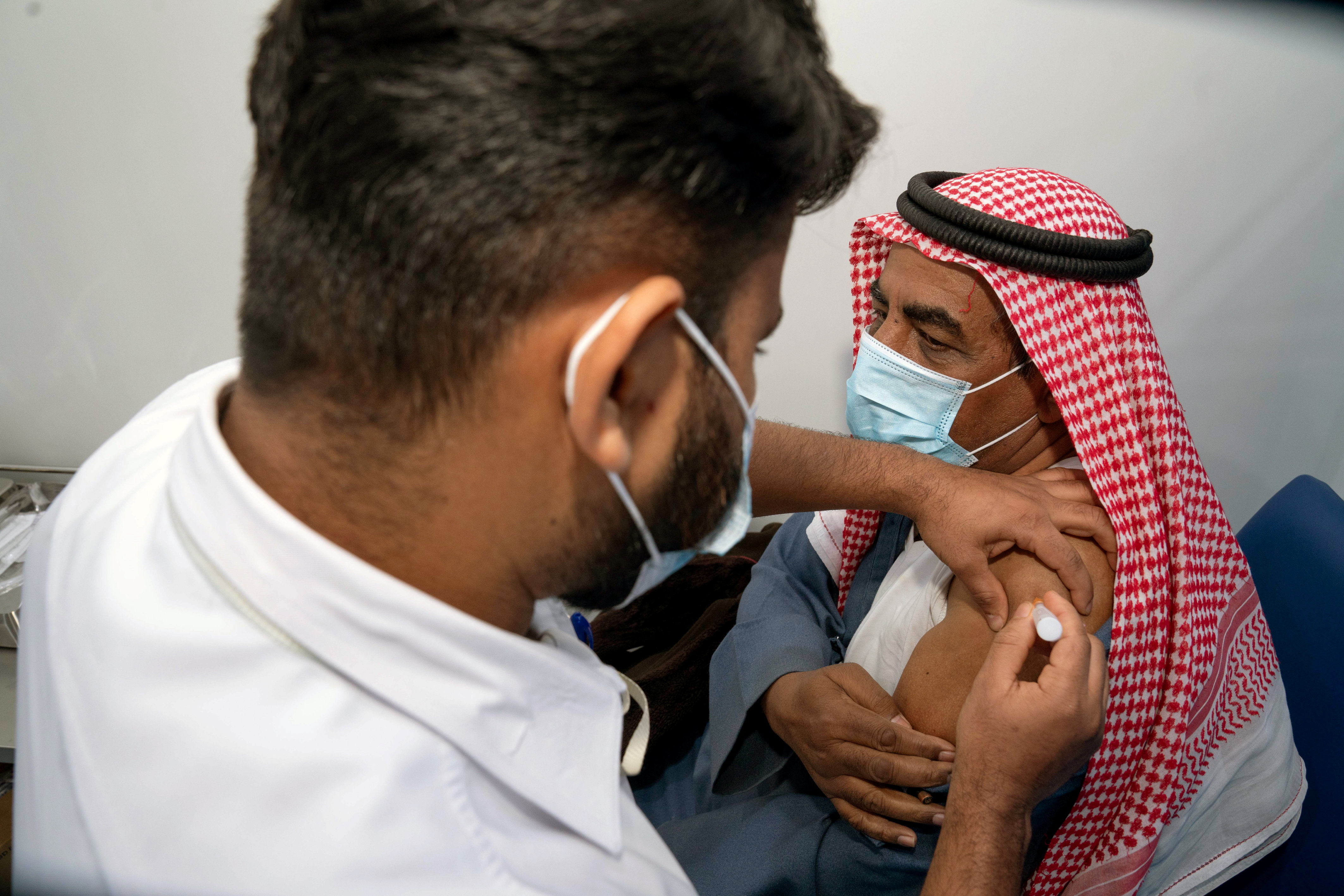 A Kuwai man, Abdulla al Anazi, gets a dose of a coronavirus disease (COVID-19) vaccine in Kuwait City