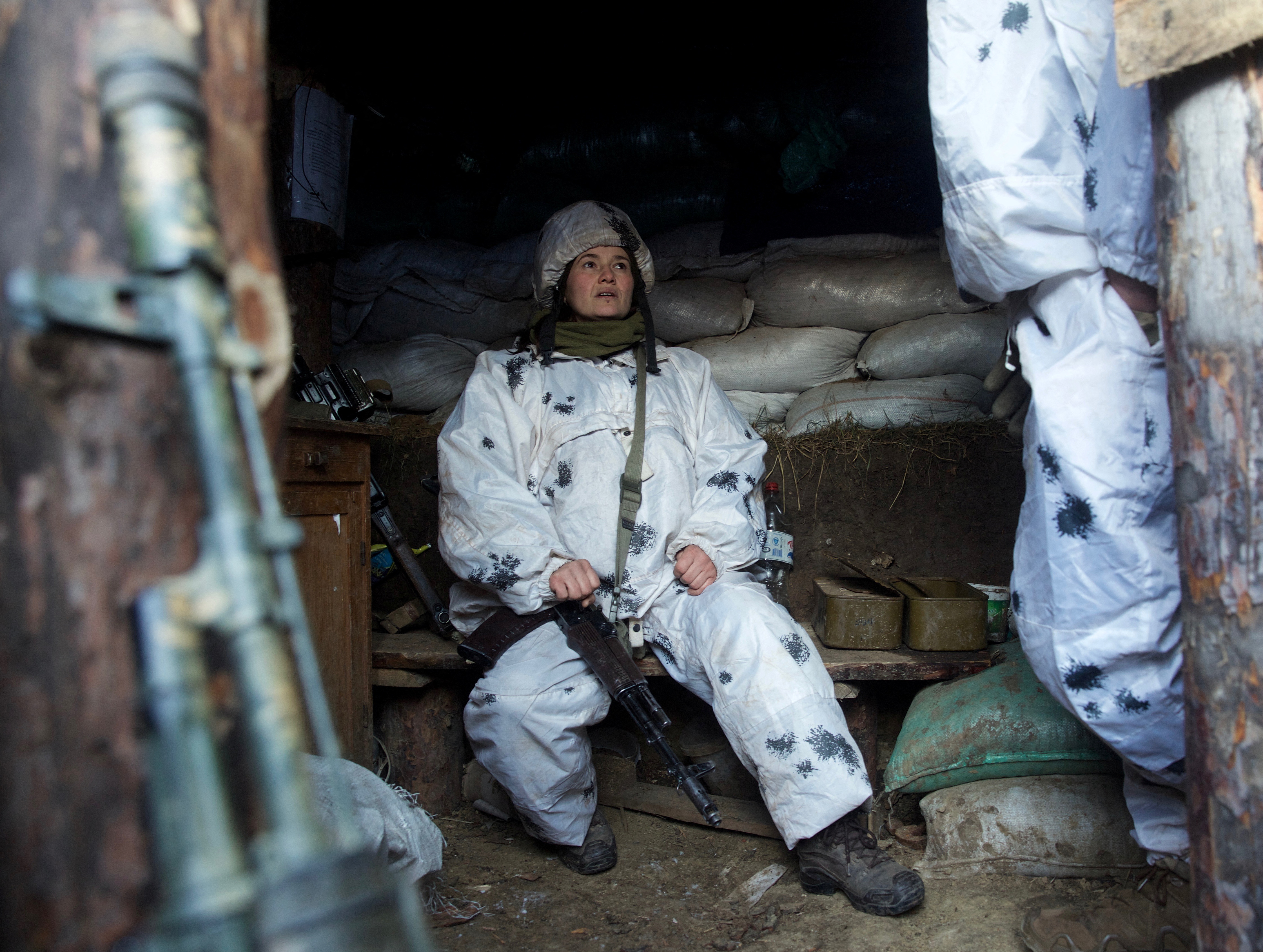 A service member of the Ukrainian armed forces is seen at combat positions in Donetsk region