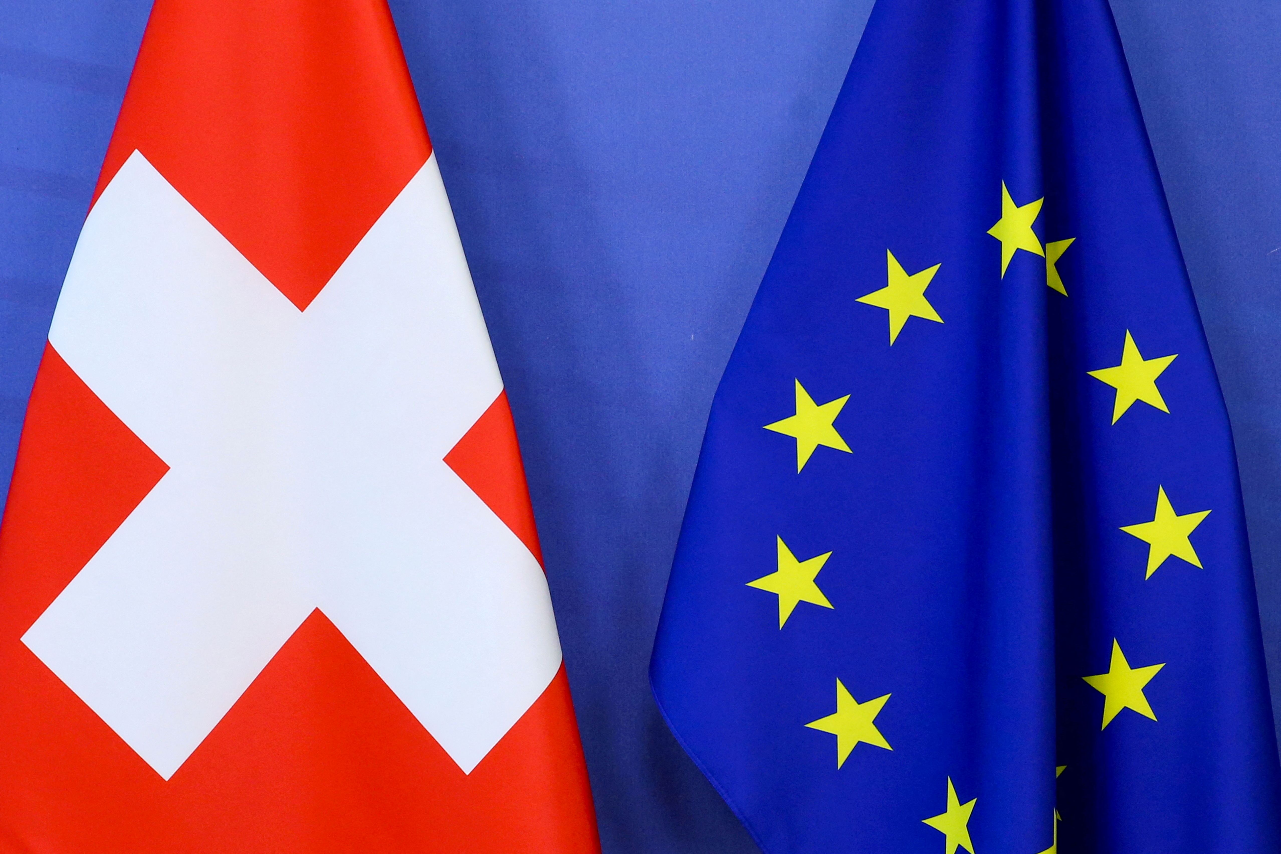 Switzerland's national flag and the European Union flag are seen at the European Commission building in Brussels, Belgium April 23, 2021.
