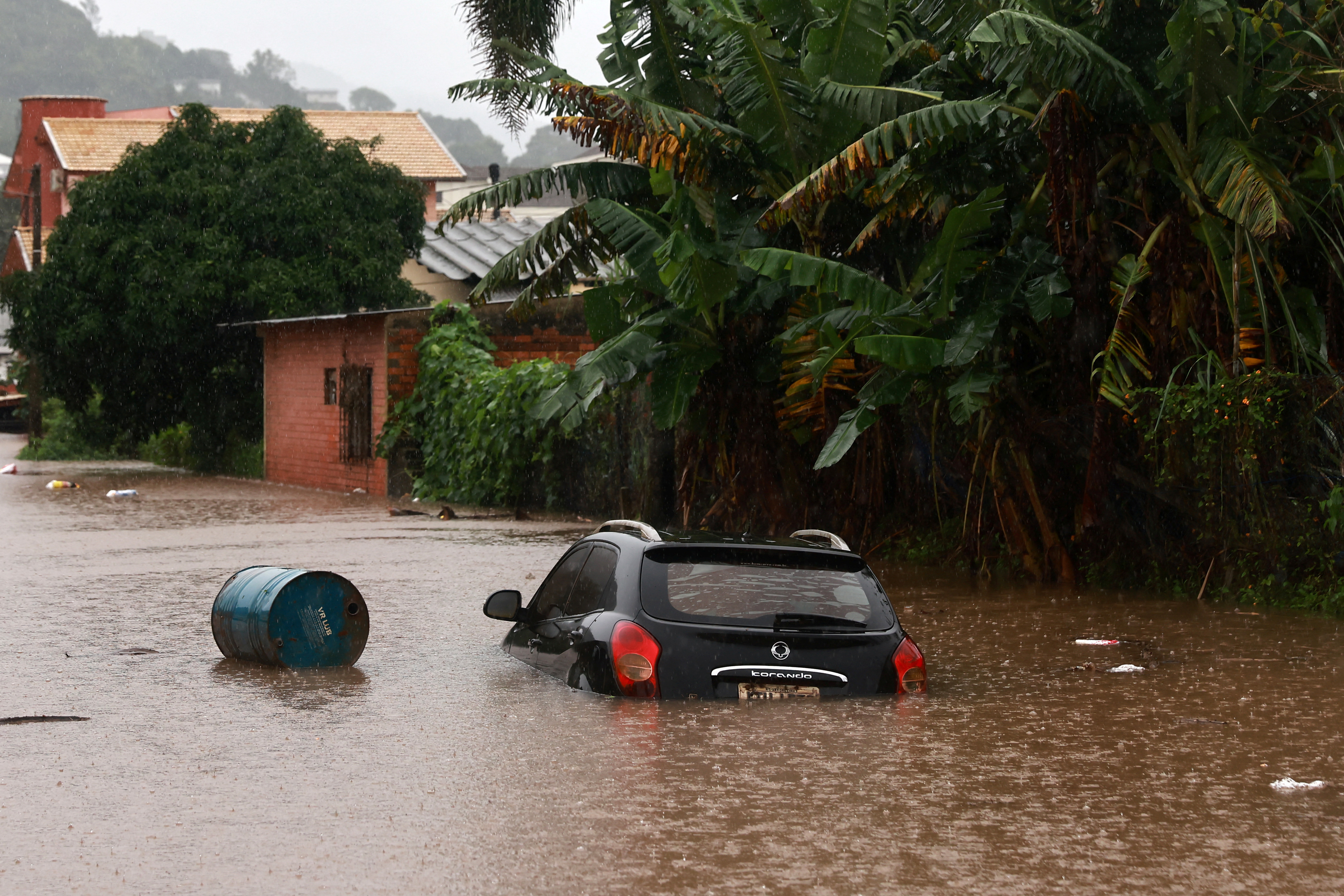 A car stands in the flooded road near the Taquari River, during heavy rains in the city of Encantado in Rio Grande do Sul