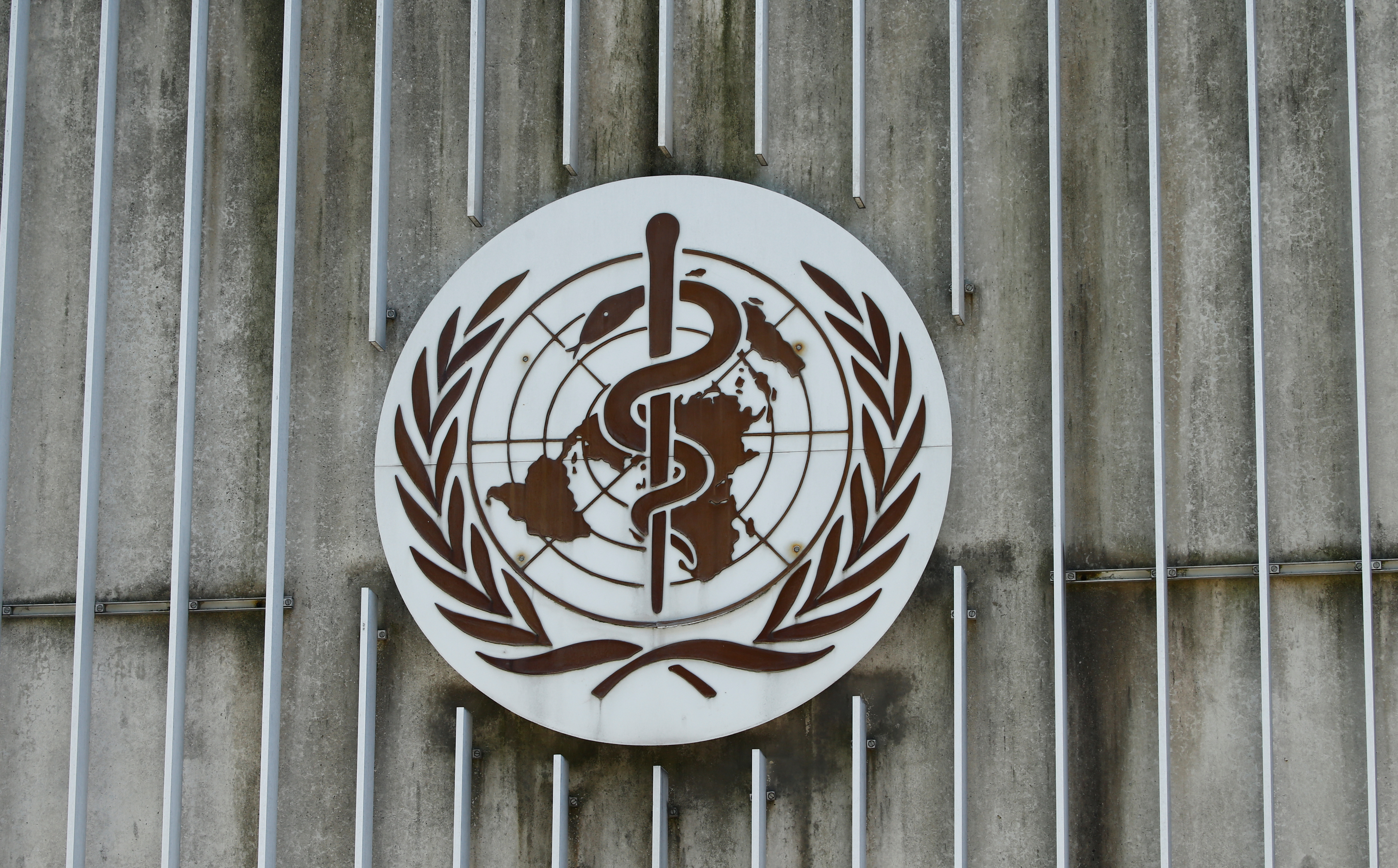 A logo is pictured on the headquarters of the WHO in Geneva