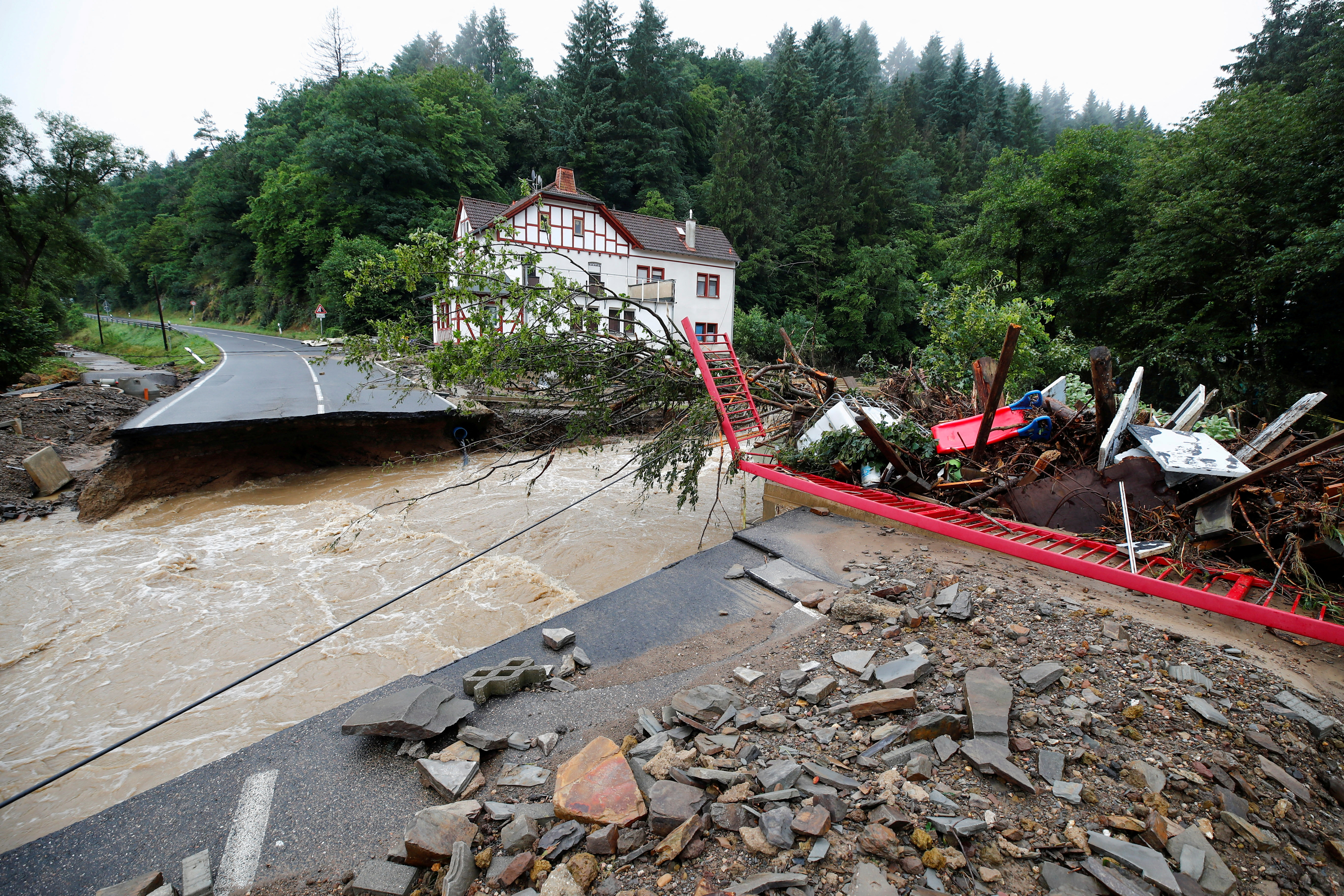 A destroyed road next to the Ahr river is seen on a flood-affected area in Schuld