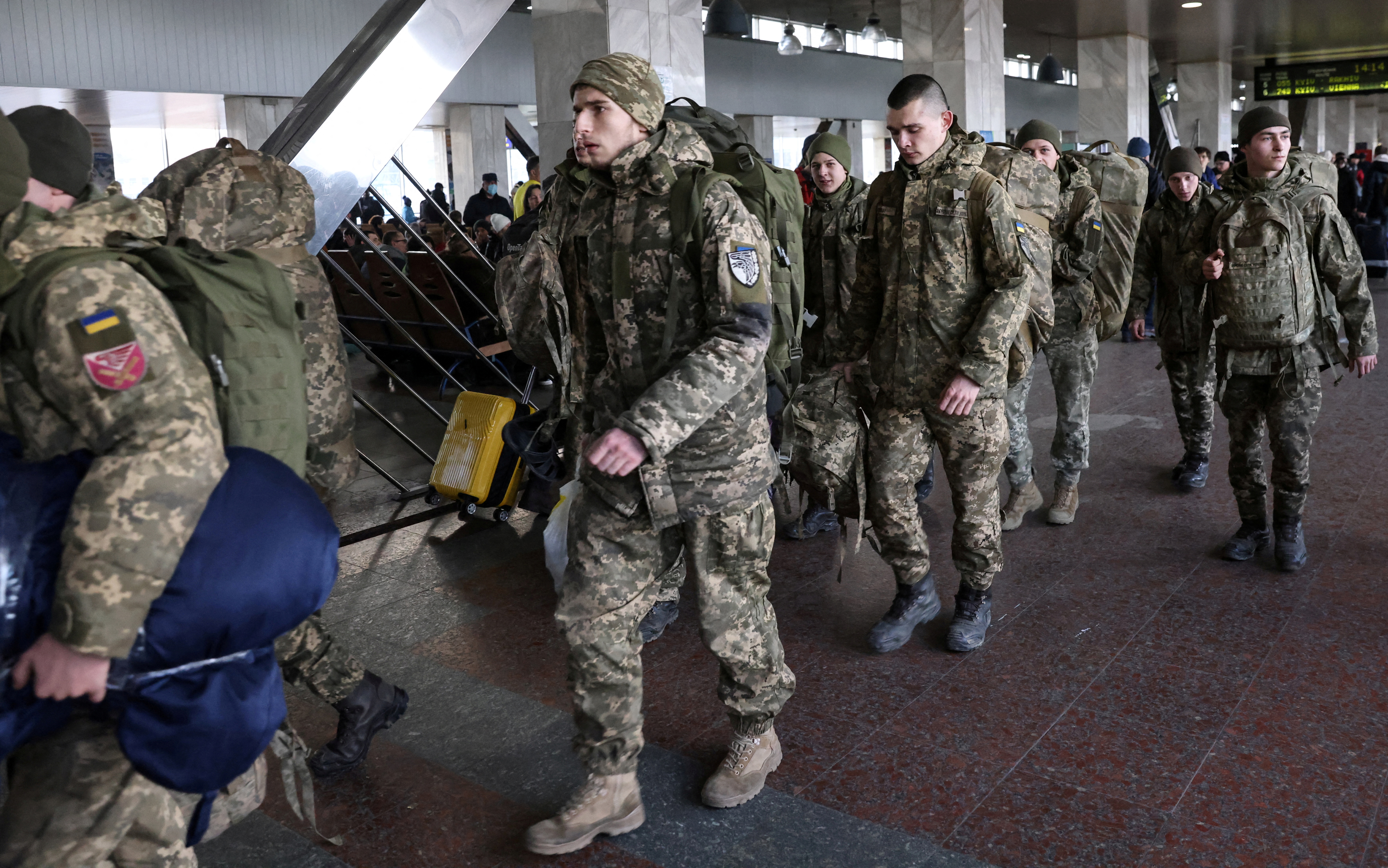 Ukrainian soldiers walk at Kyiv central train station, Ukraine, February 25, 2022. REUTERS/Umit Bektas