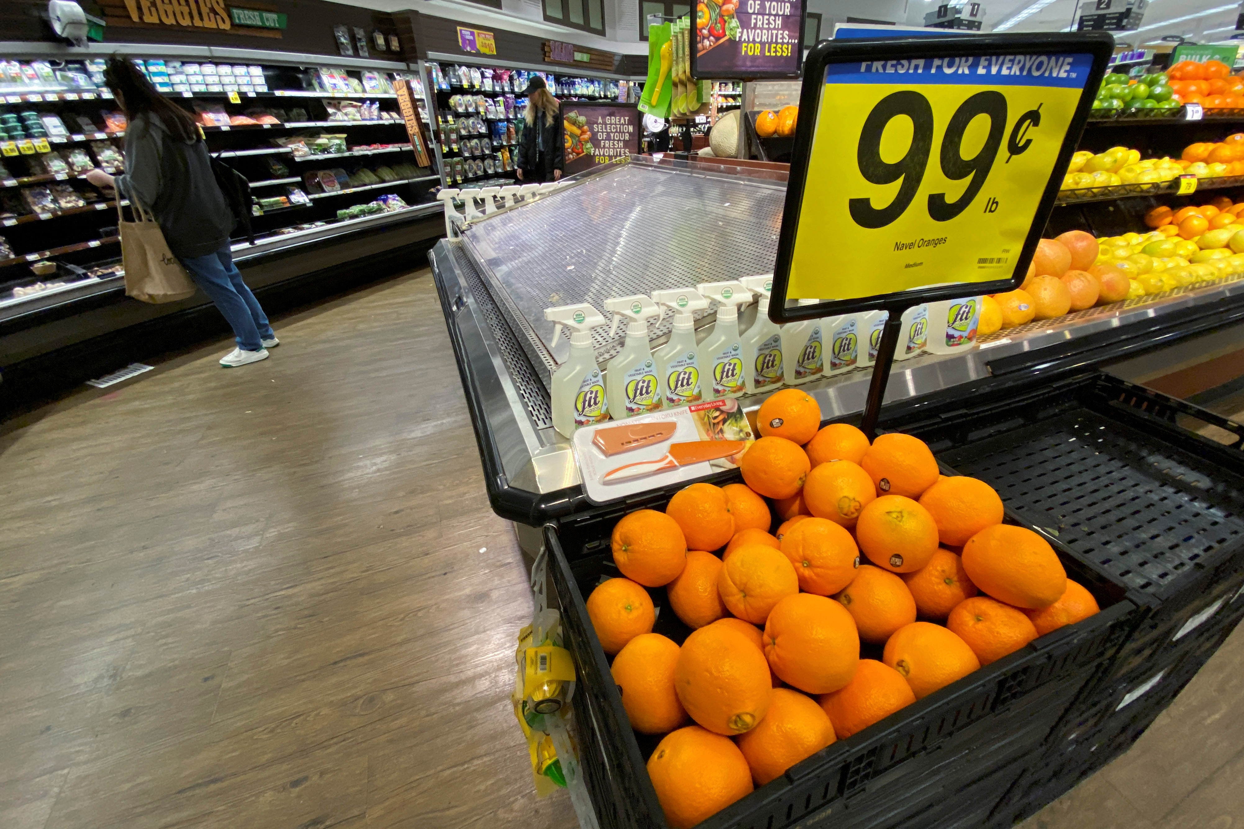 Oranges are displayed for sale at the produce area as a customer browses grocery store shelves inside Kroger Co.'s Ralphs supermarket amid fears of the global growth of coronavirus cases, in Los Angeles