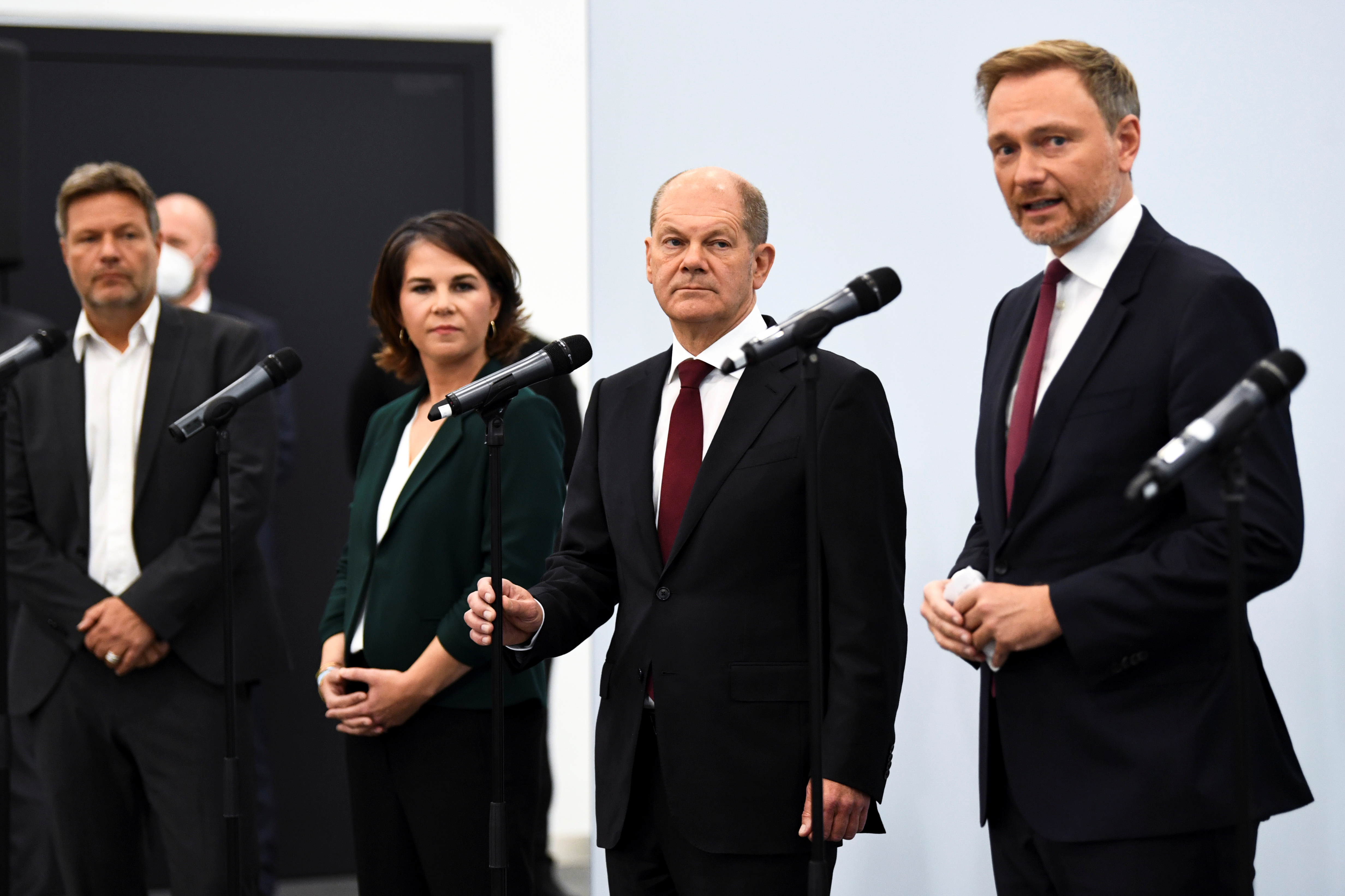 Germany's Greens party co-leaders Robert Habeck and Annalena Baerbock and Social Democratic Party (SPD) top candidate for chancellor Olaf Scholz listen to Free Democratic Party (FDP) leader Christian Lindner as he gives a statement following a meeting for exploratory talks for a possible new government coalition in Berlin, Germany, October 15, 2021. REUTERS/Annegret Hilse