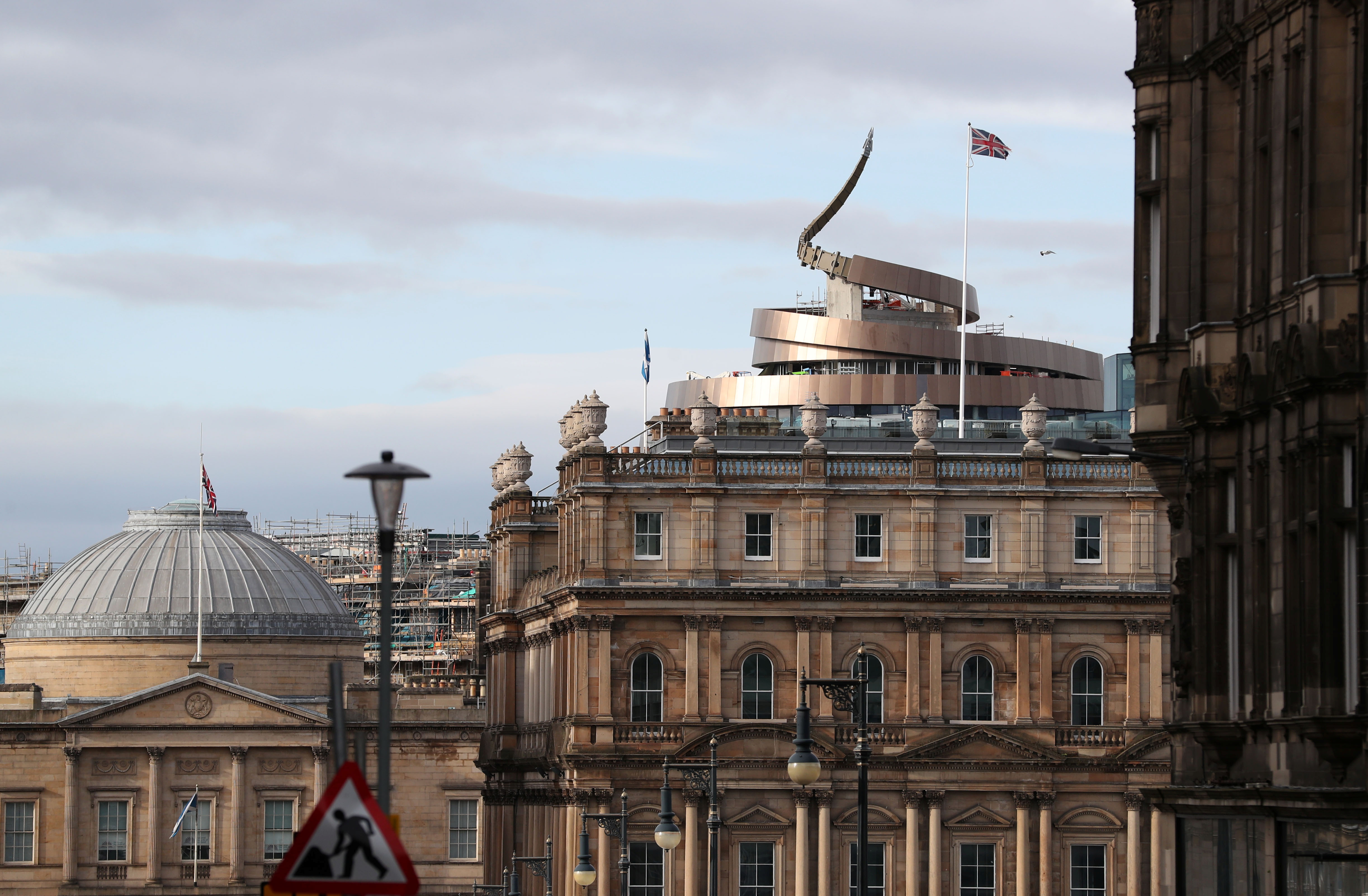 Union and Scotland flags fly over buildings in central Edinburgh