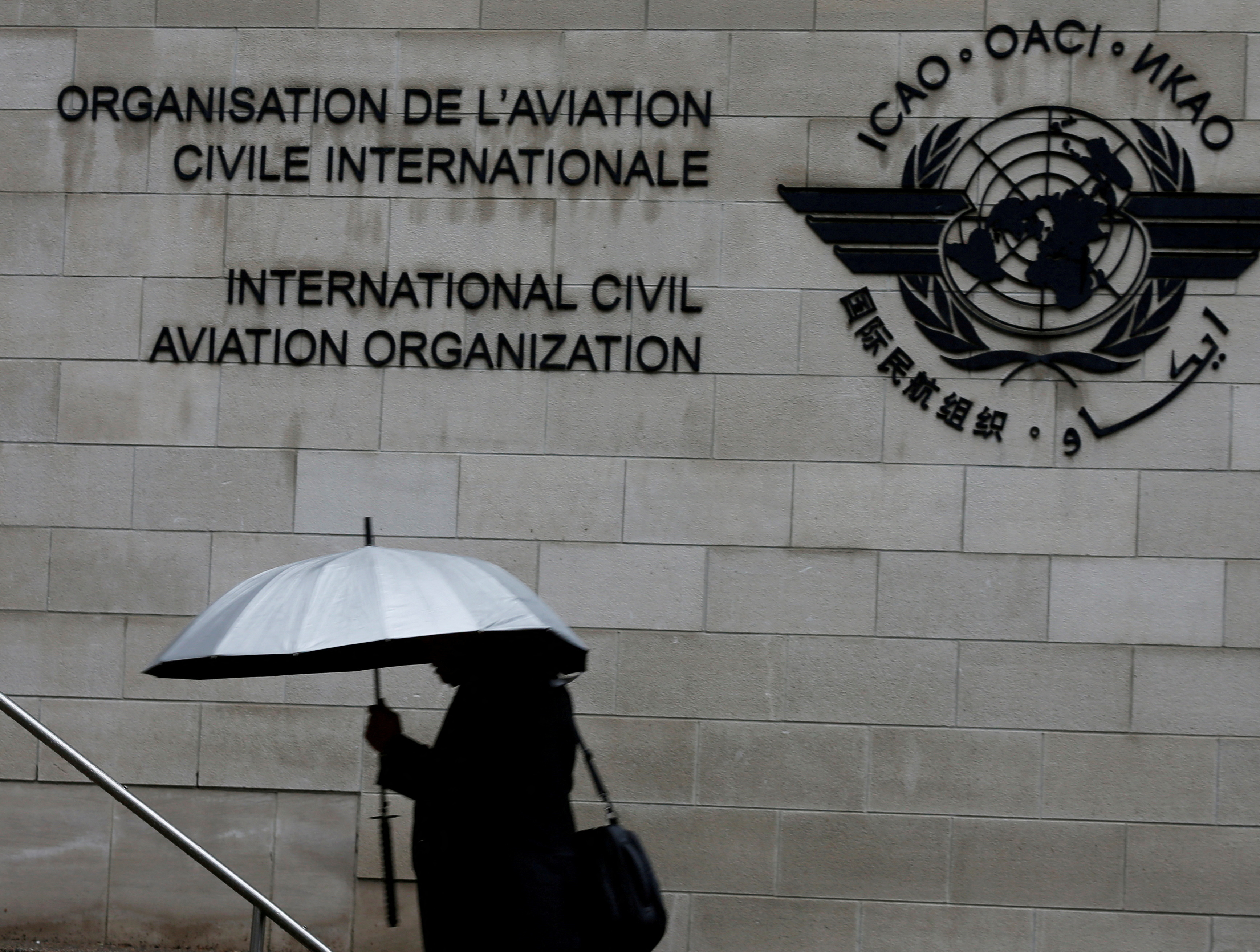 A pedestrian walks past the International Civil Aviation Organization (ICAO) headquarters building in Montreal