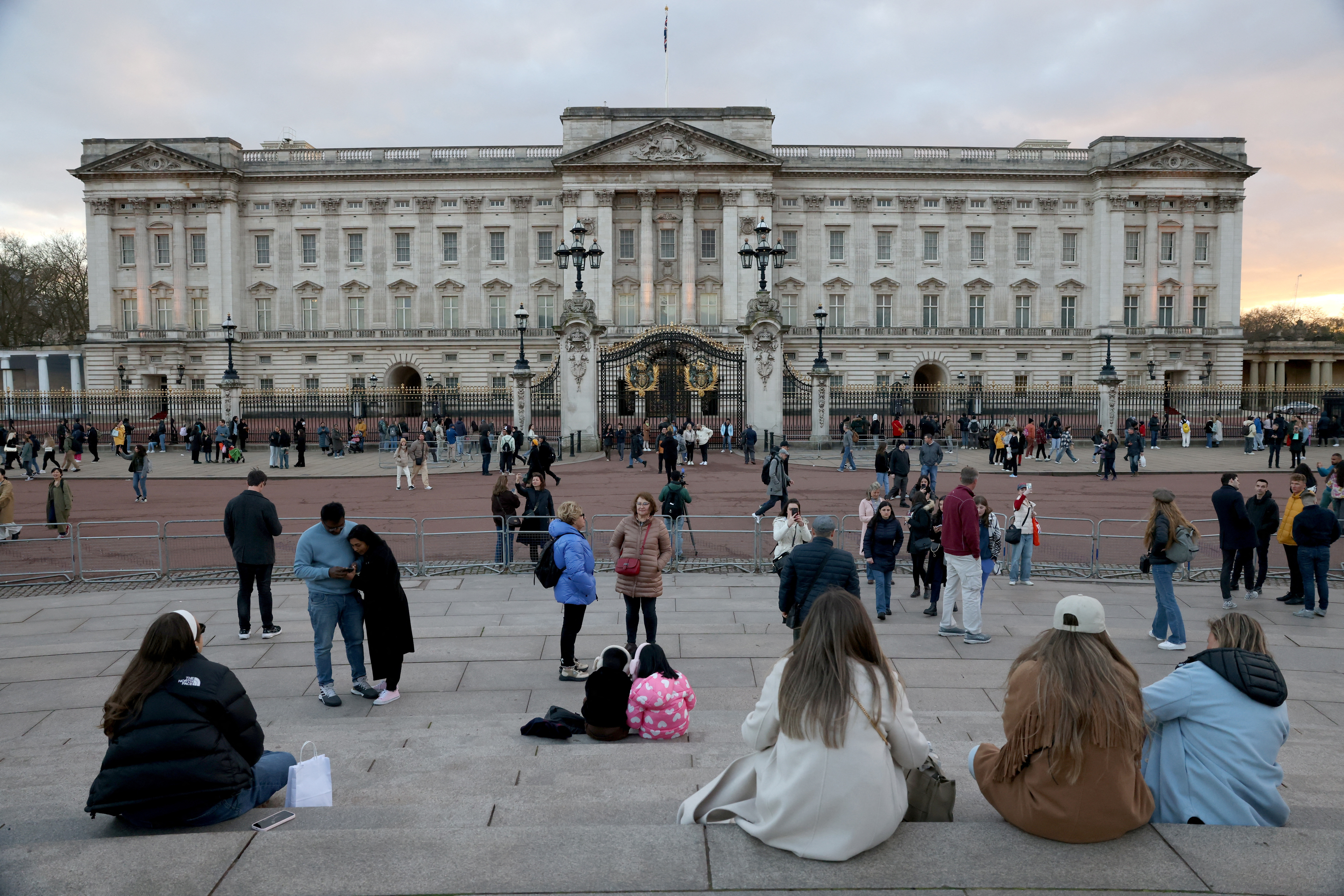 People gather outside Buckingham Palace in London