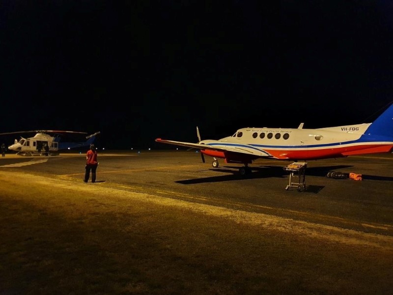 Royal Flying Doctors prepare to airlift two men who were attacked by a crocodile late on Friday, in Lockhart River, Queensland, Australia August 6, 2021.  ROYAL FLYING DOCTOR SERVICE (QUEENSLAND SECTION) (RFDS)/Handout via REUTERS   