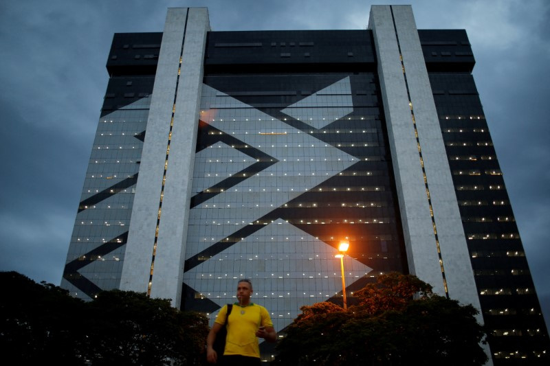 A man walks in front of Banco do Brasil headquarters building  in Brasilia