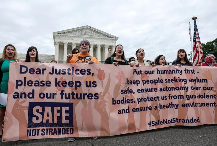 Demonstrators call on the U.S. Supreme Court to overturn the 