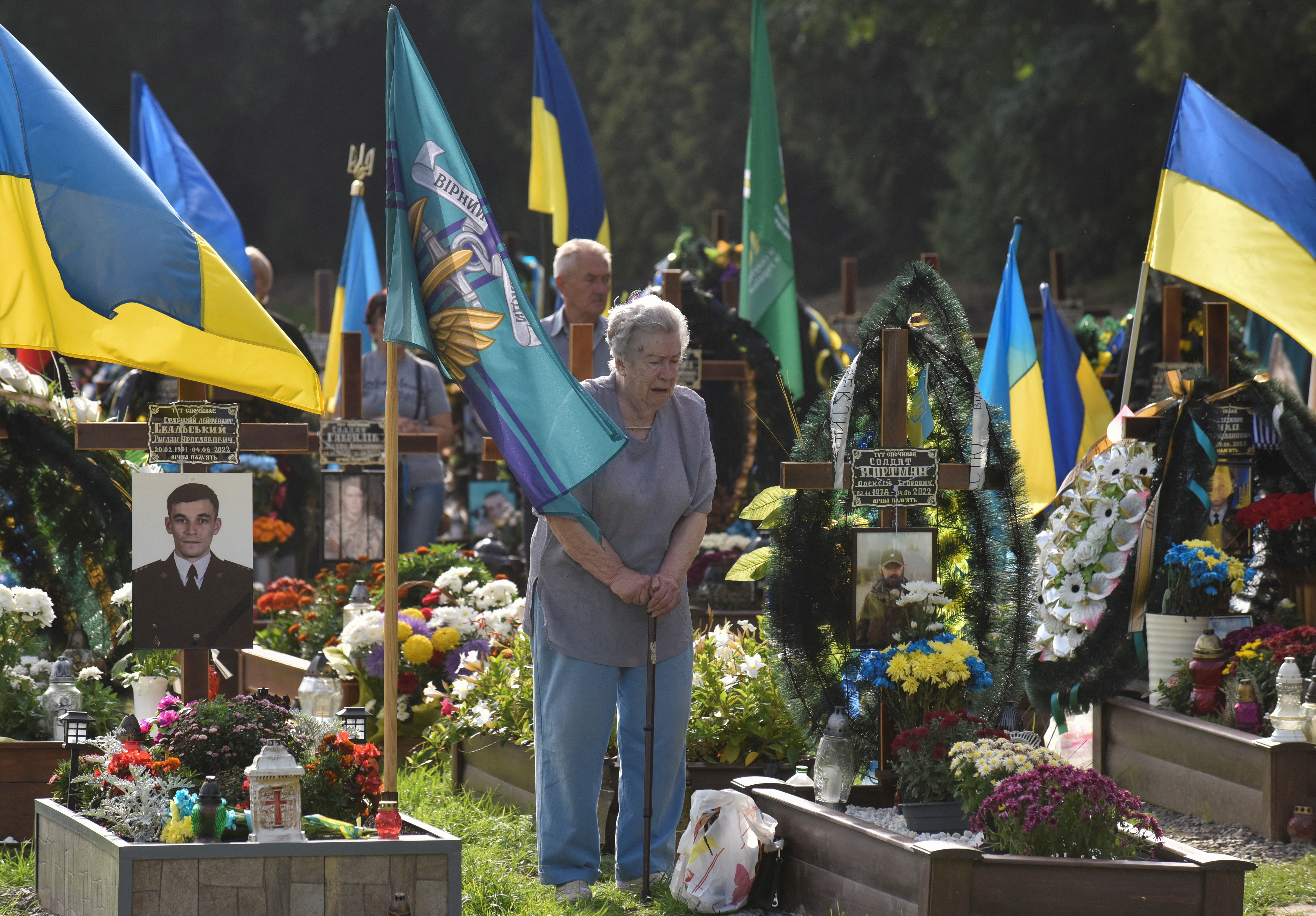 A woman visits the tomb of her relative on Independence Day in Lviv