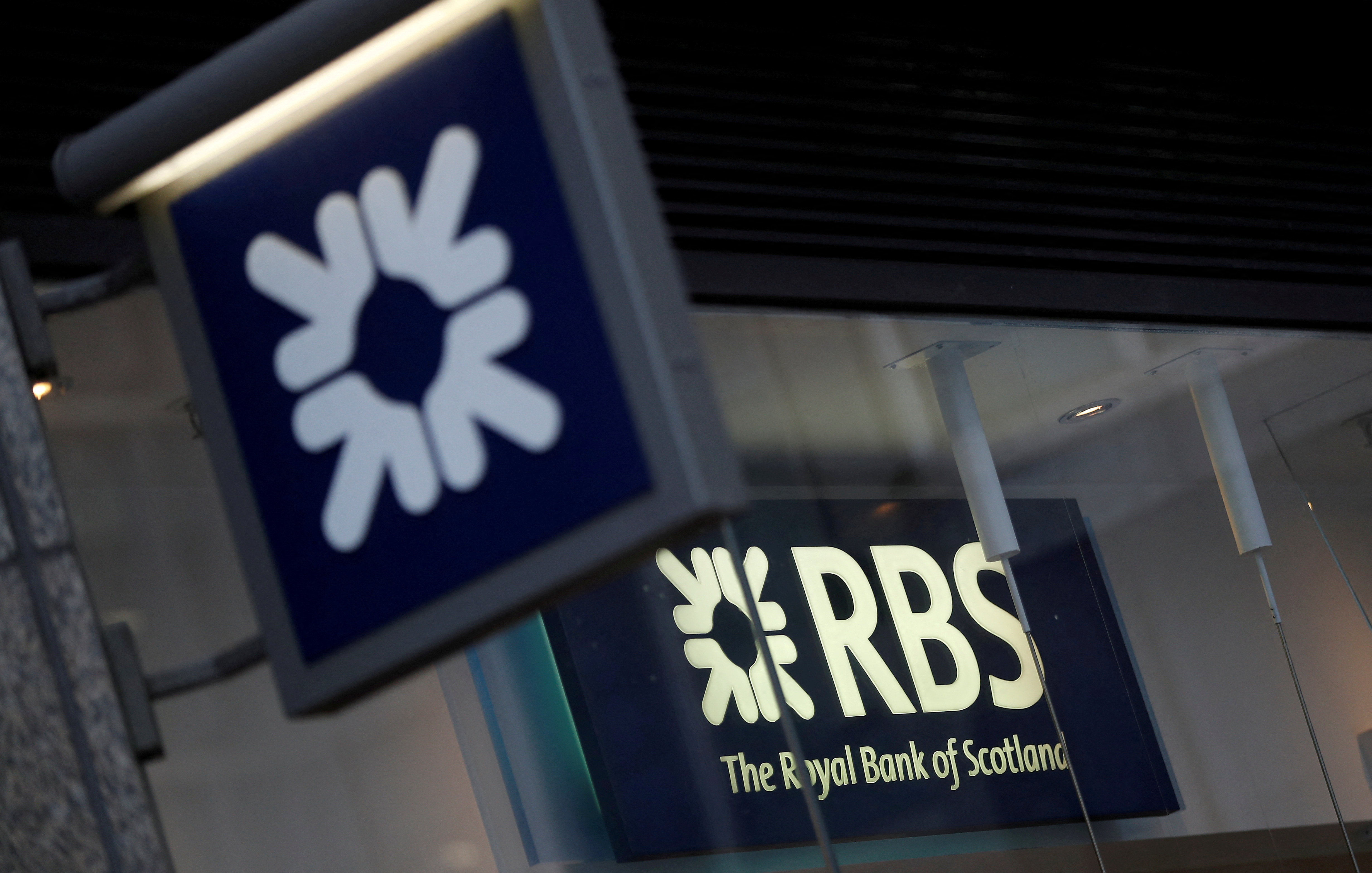 Royal Bank of Scotland signs are seen at a branch of the bank, in London