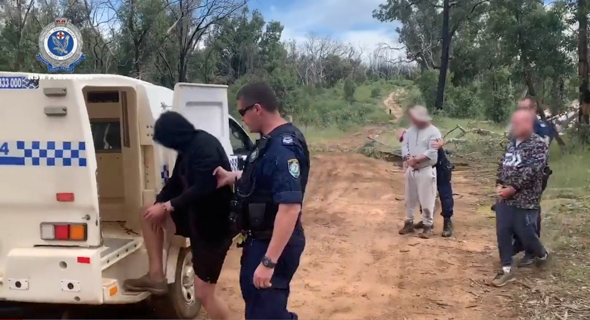 Persons are detained by Australian Federal Police after its Operation Ironside against organised crime in this undated handout photo released June 8, 2021. Australian Federal Police/Handout via REUTERS 