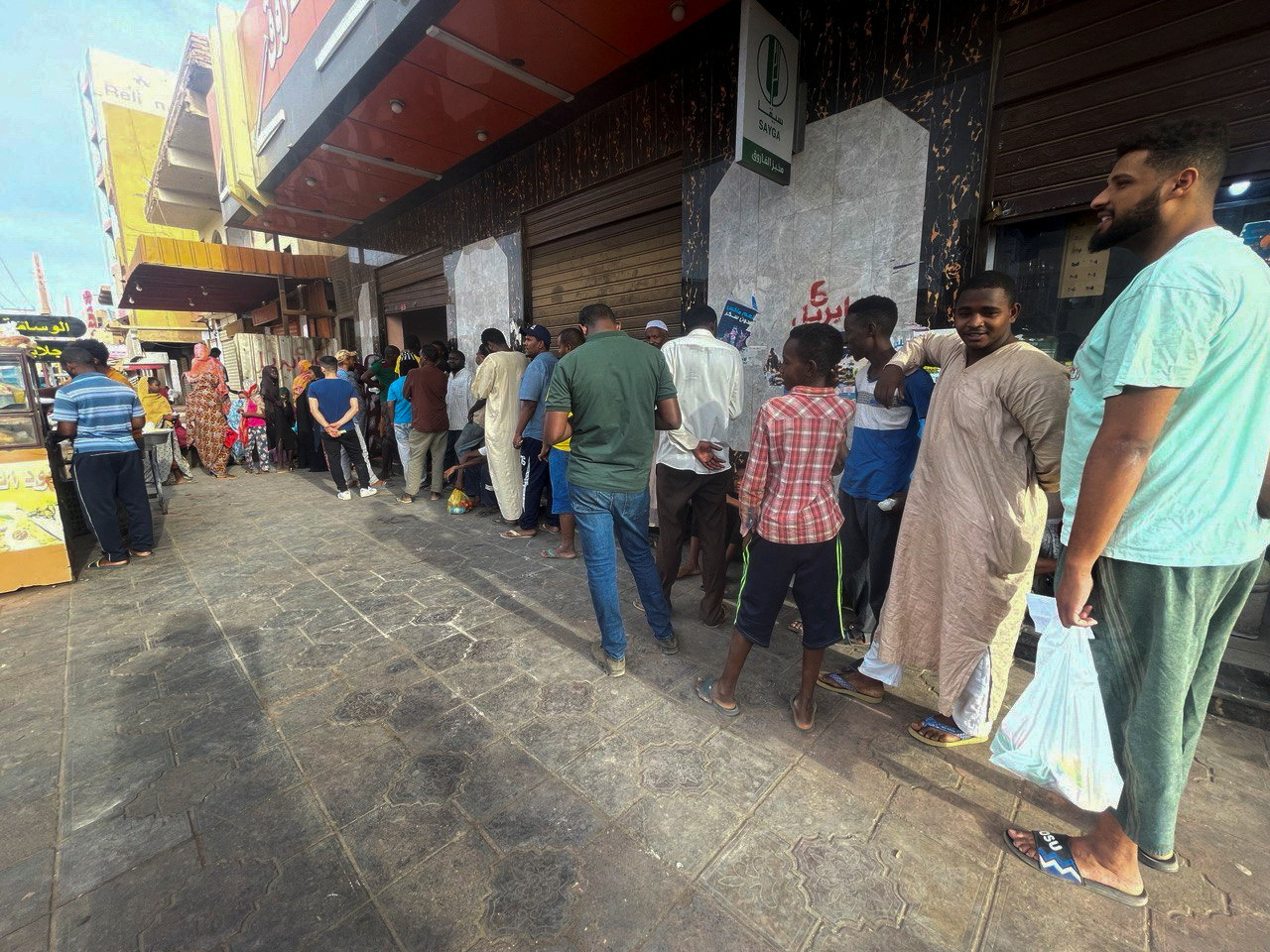 People gather to get bread in Khartoum