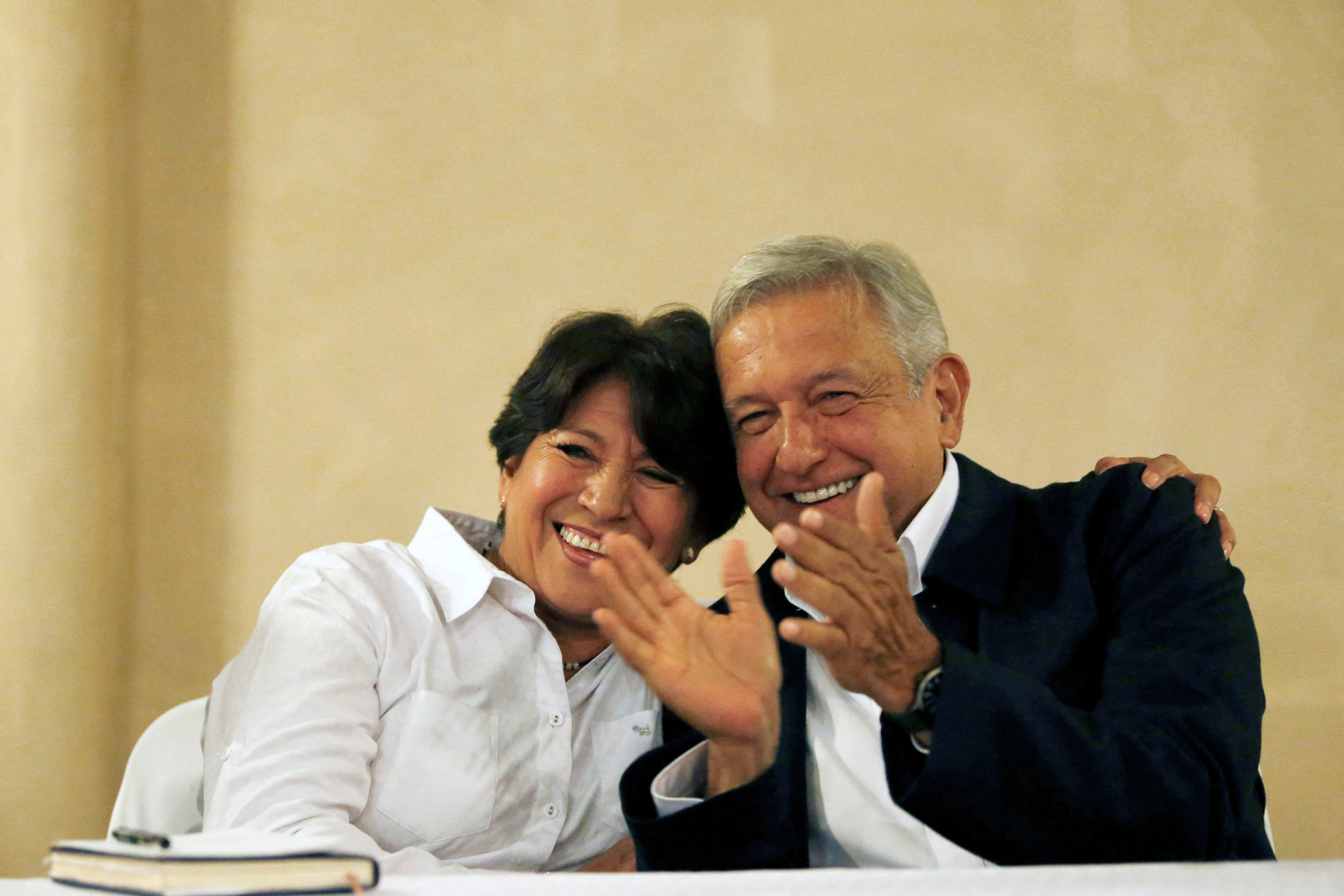 Delfina Gomez of MORENA, candidate for the governor of the State of Mexico, smiles next to Andres Manuel Lopez Obrador, leader of MORENA during a news conference in Mexico City