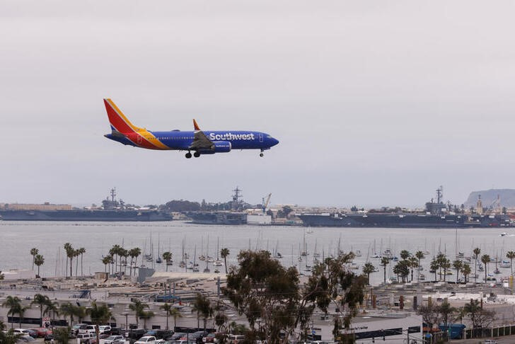 Southwest airliner passes U.S. Navy aircraft carries as it lands in San Diego