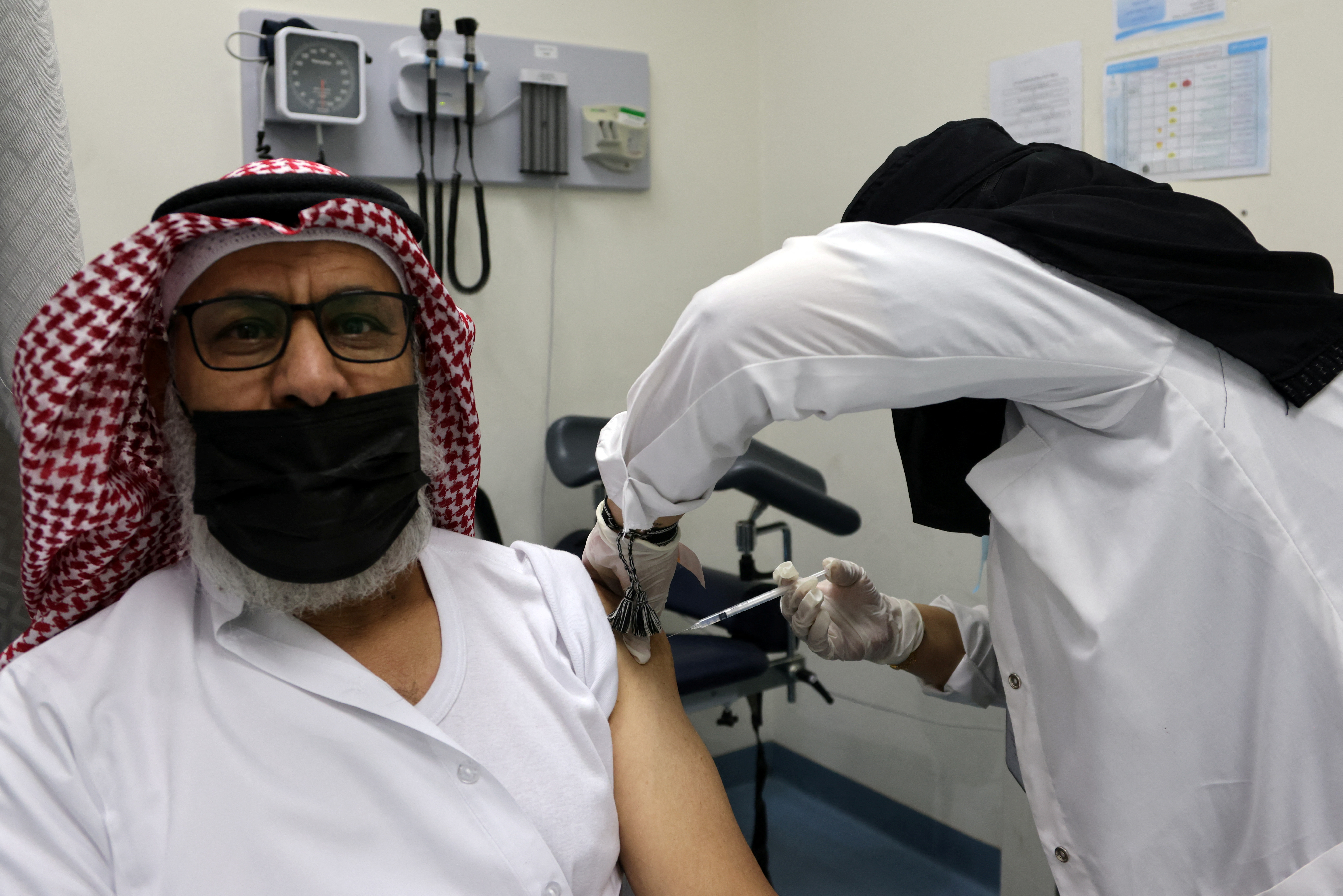 A Saudi man receives a vaccine against COVID-19 at Prince Sultan Complex Health Center in Riyadh