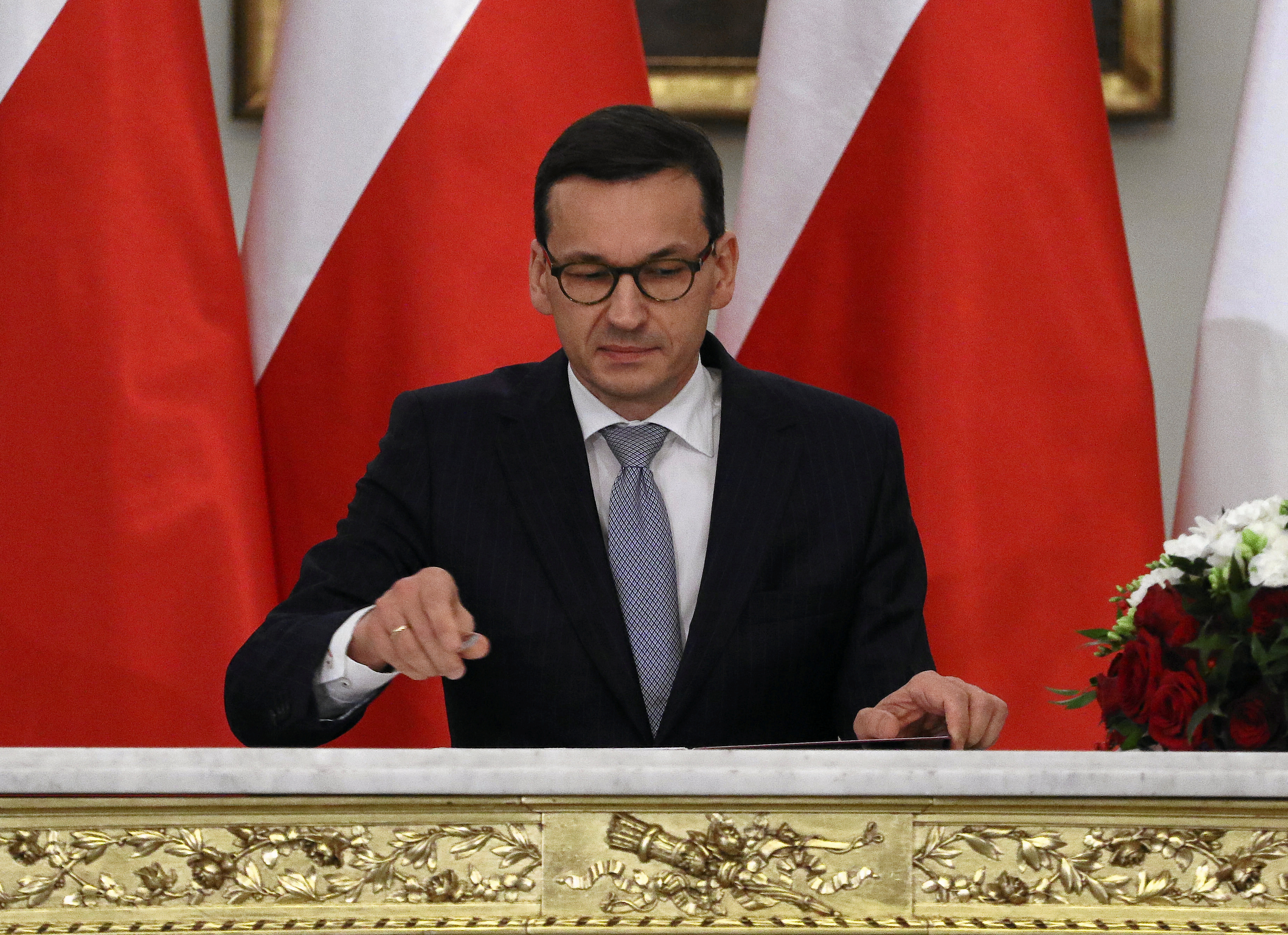 Newly appointed Polish Prime Minister Morawiecki reacts after receiving his nomination from President Duda during a government swearing-in ceremony in Warsaw