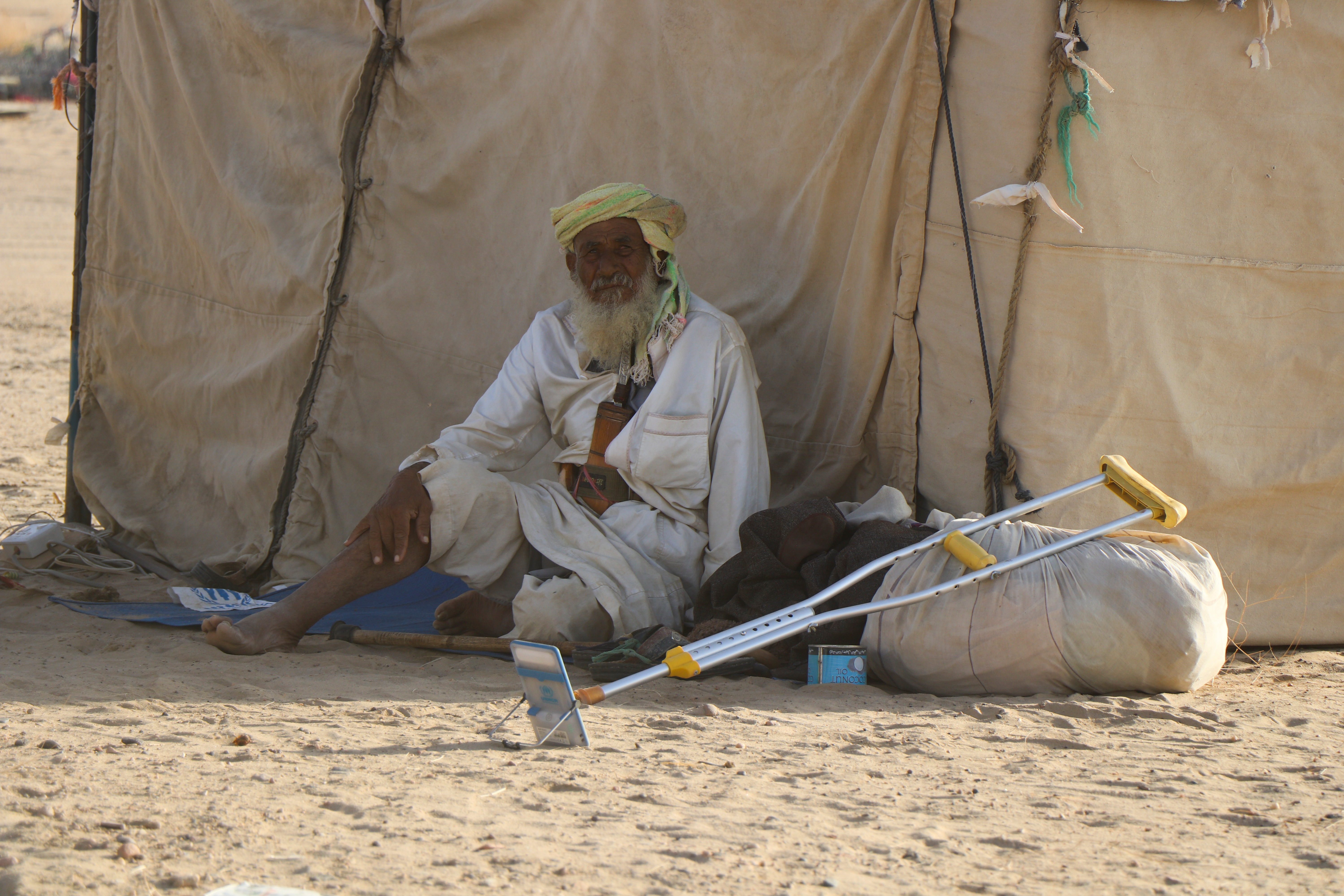 Man sits outside a tent at a camp for internally displaced people (IDPs) in Marib, Yemen