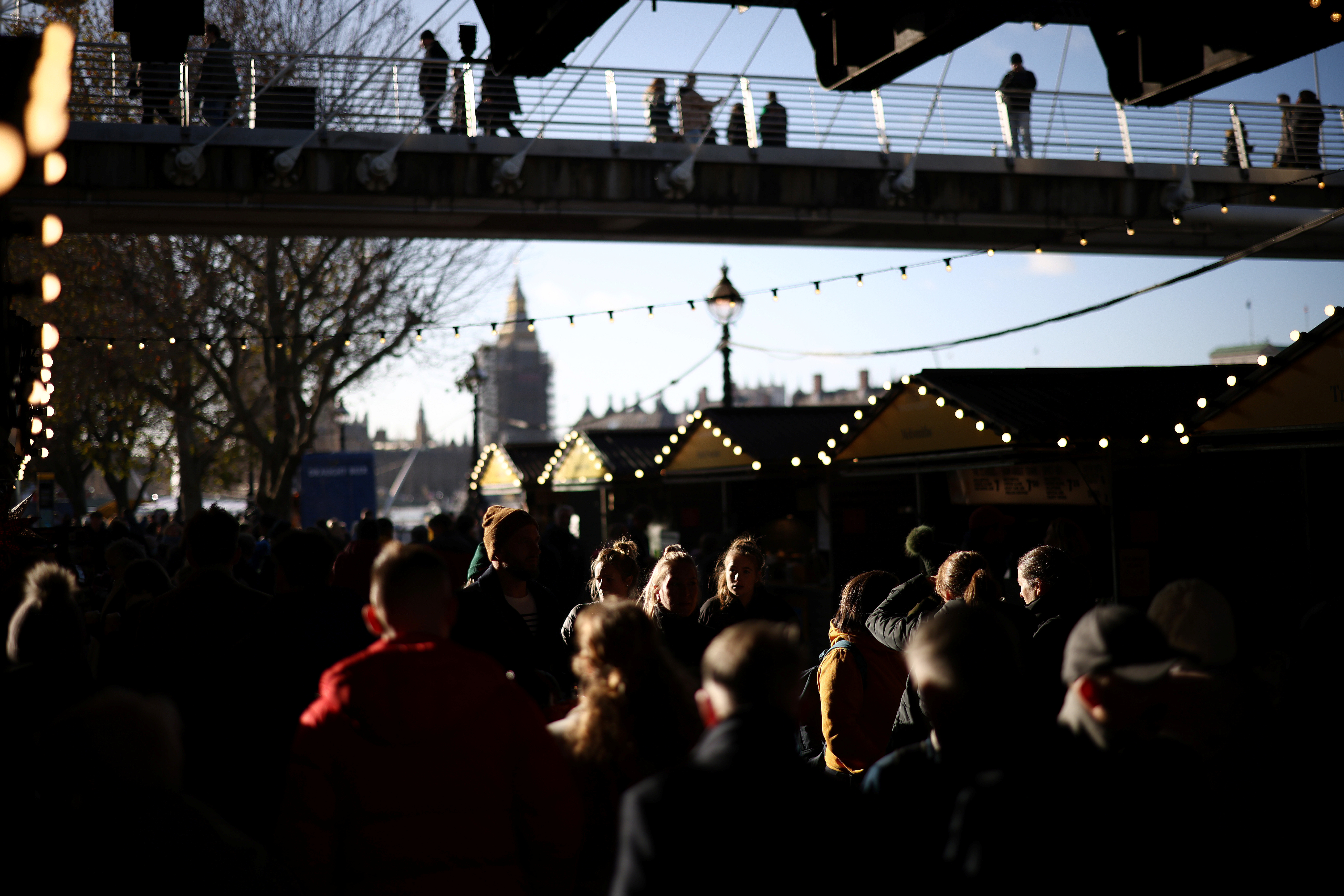 People walk through a Christmas-themed market on the South Bank, amid the coronavirus disease (COVID-19) outbreak in London, Britain, December 4, 2021. REUTERS/Henry Nicholls