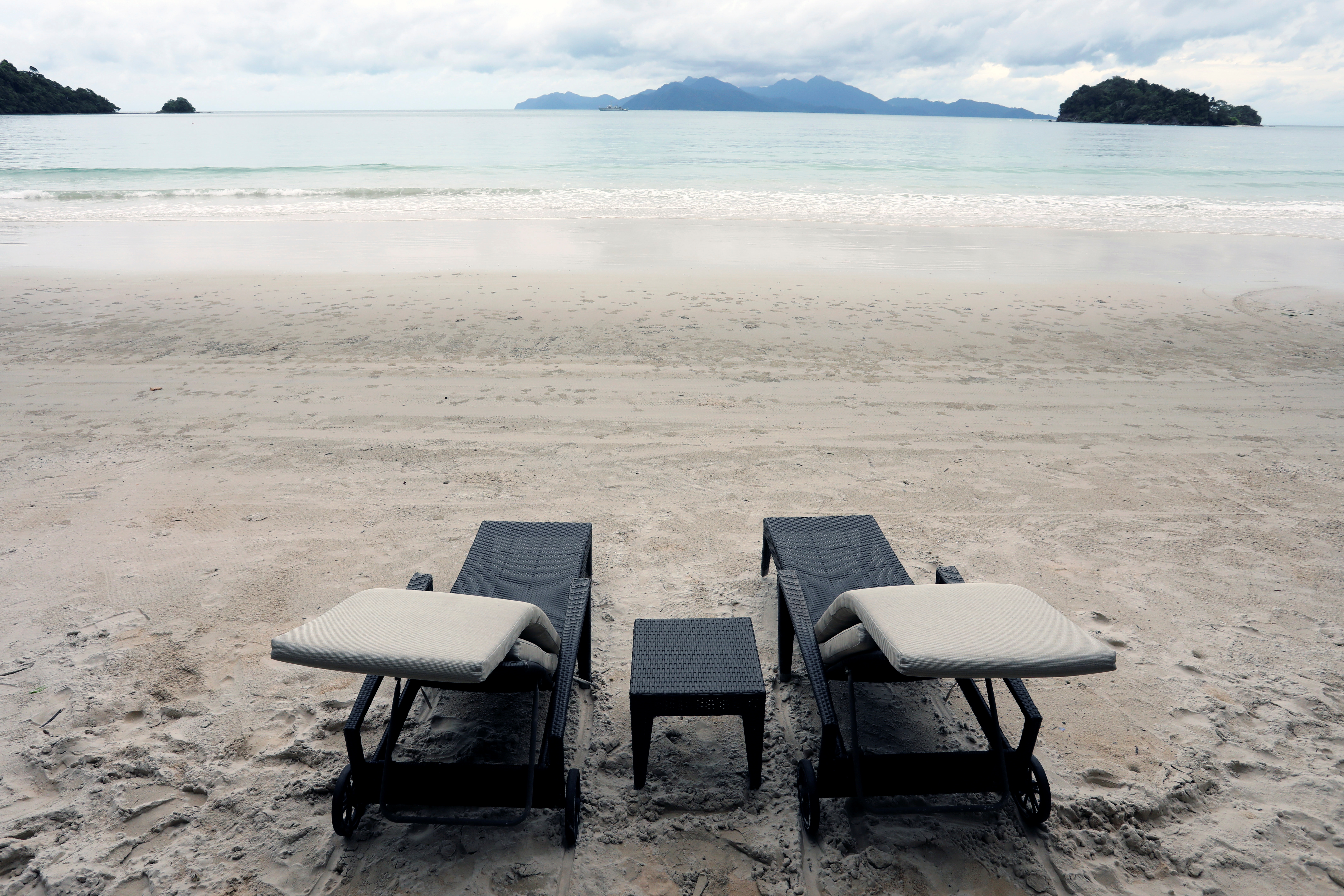 Empty chairs are seen at The Datai Langkawi resort beach in Langkawi