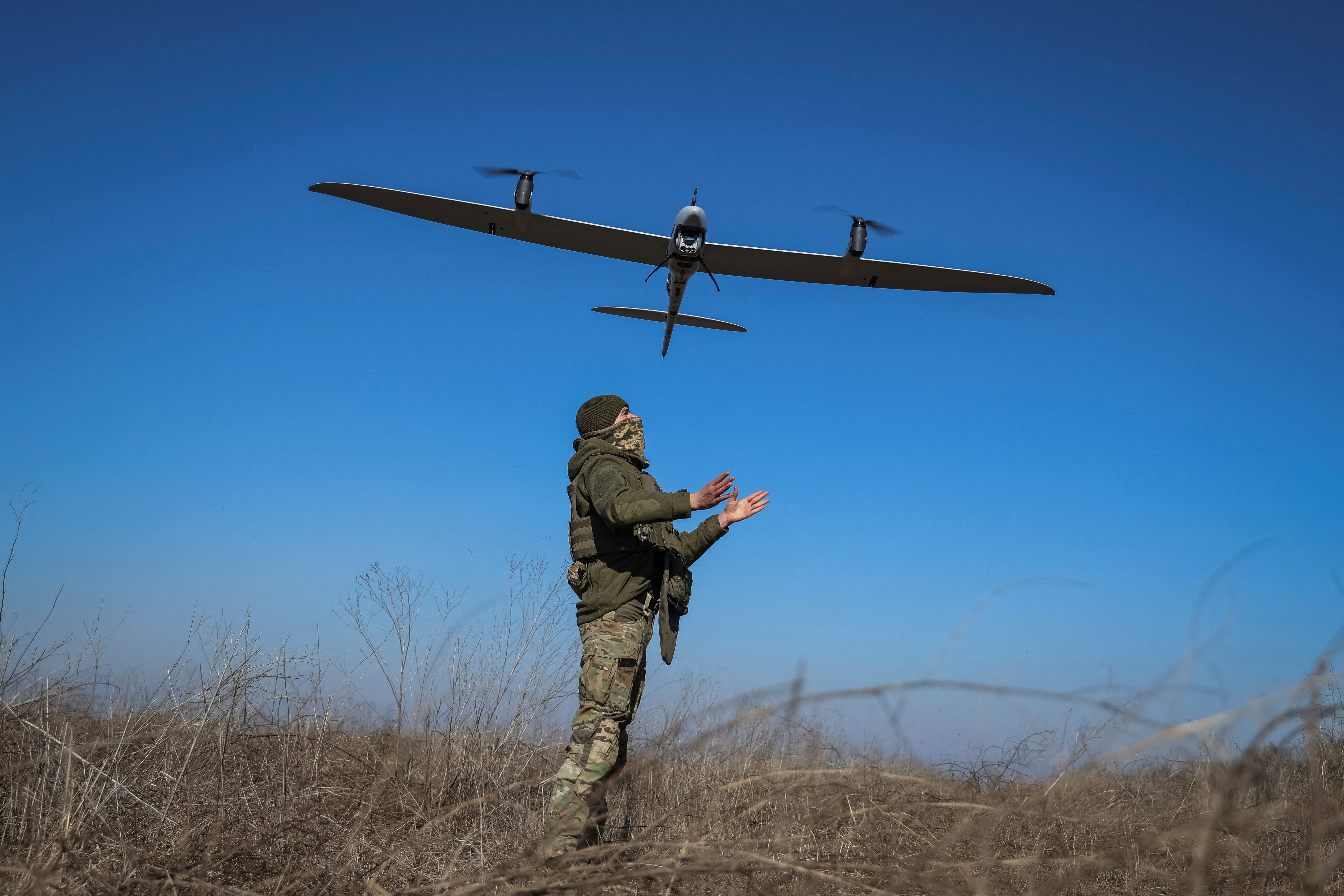 A Ukrainian serviceman launches a mid-range reconnaissance drone type Vector for flying over positions of Russian troops near the town of Bakhmut