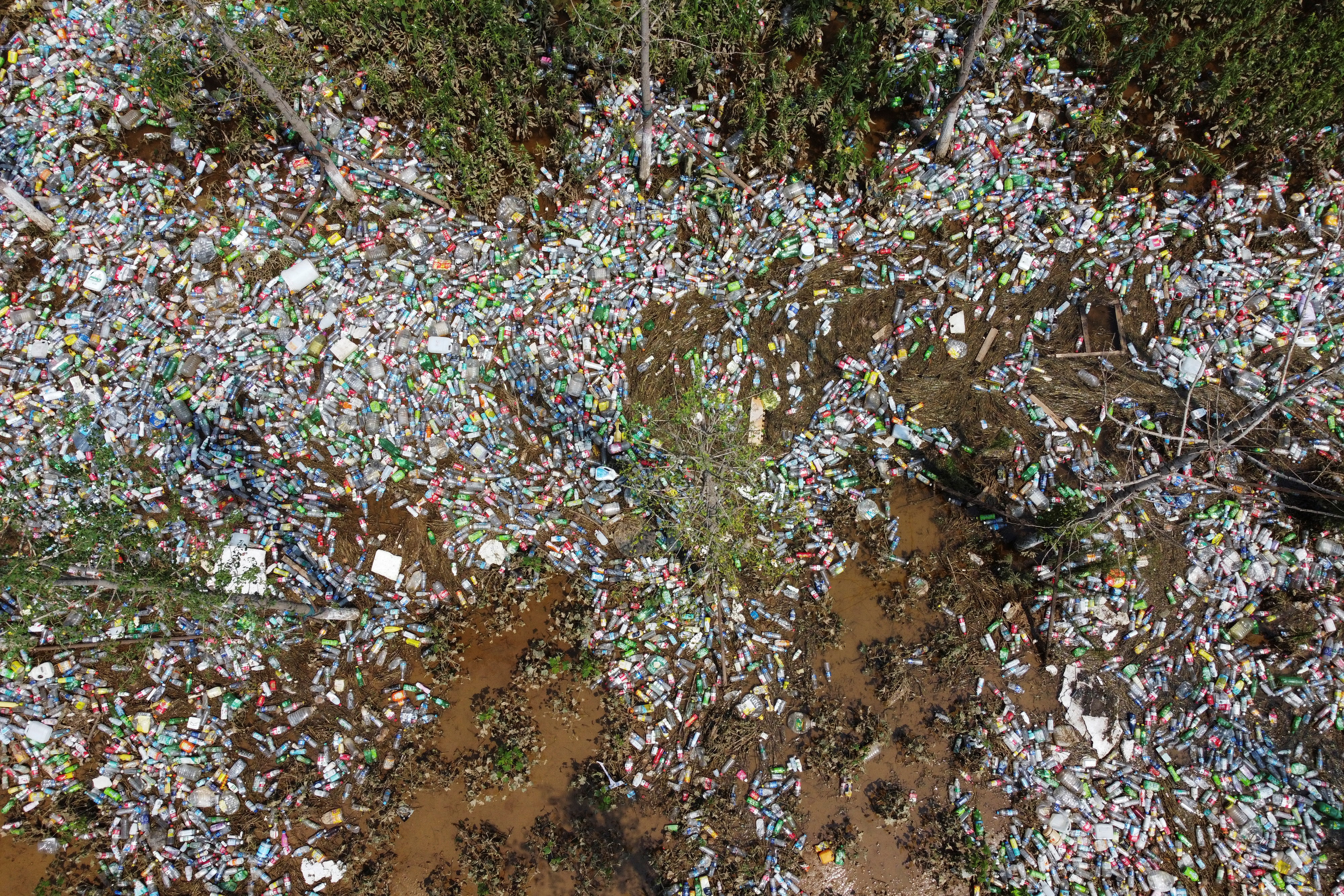 Plastic bottles are seen in a ditch where floodwaters have receded following heavy rainfall in Xinxiang