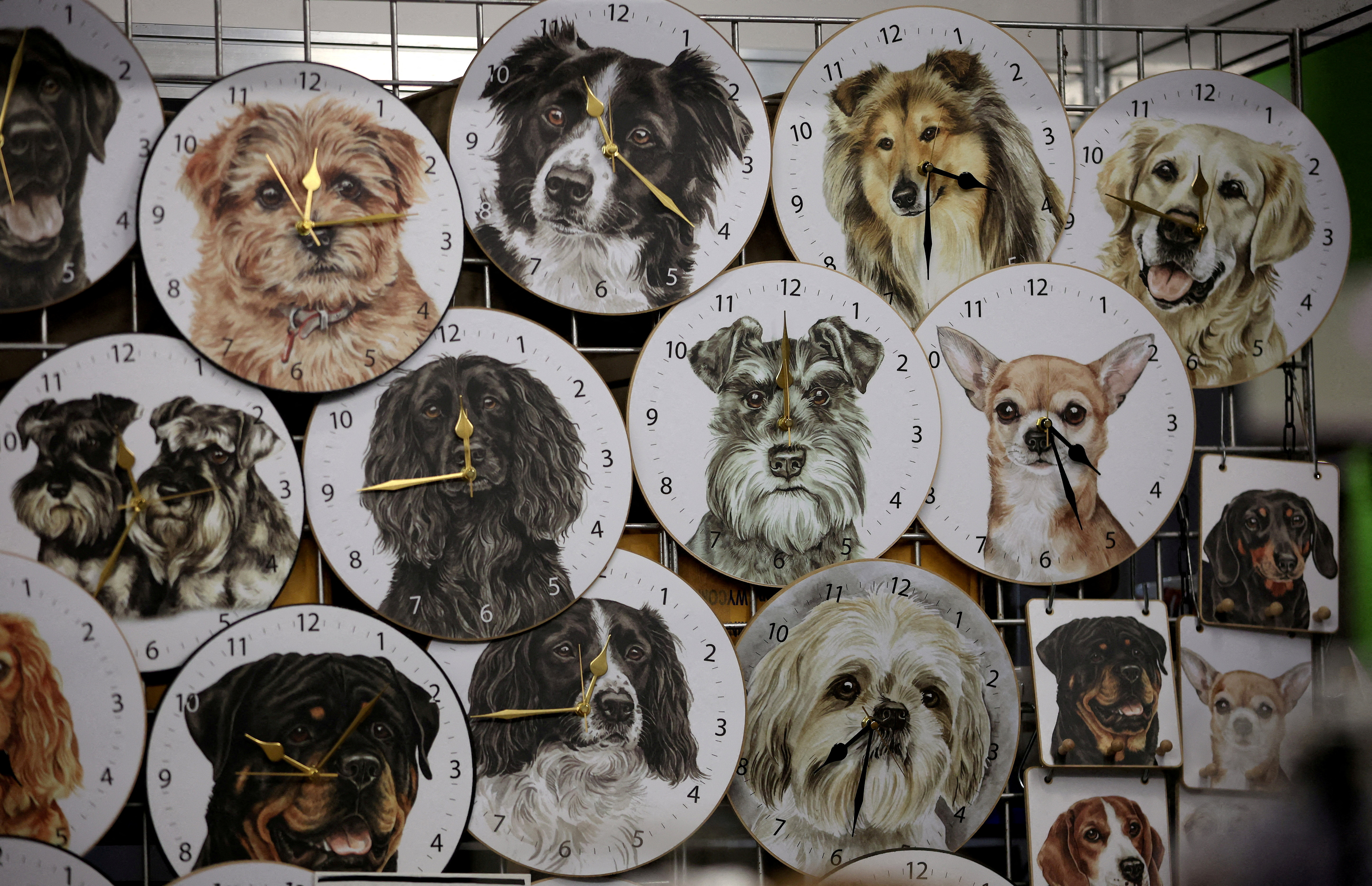 Dog themed Clocks by Christine Varley are seen for sale on the WaggyDogz trade stand on the third day of the Crufts dog show in Birmingham