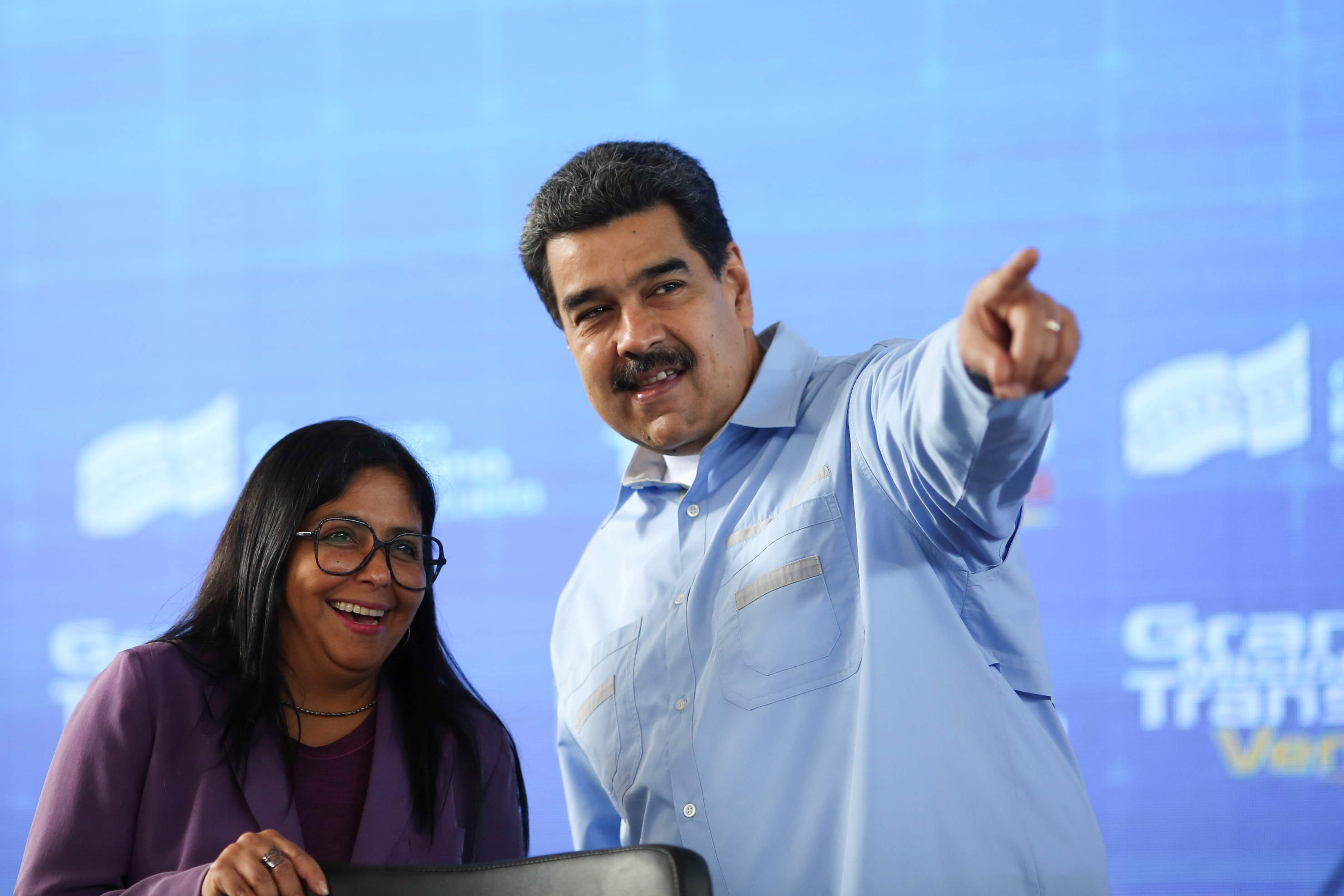 Venezuela's President Nicolas Maduro talks to Venezuela's Vice President Delcy Rodriguez during a meeting with representatives of the Venezuelan automotive sector in Caracas