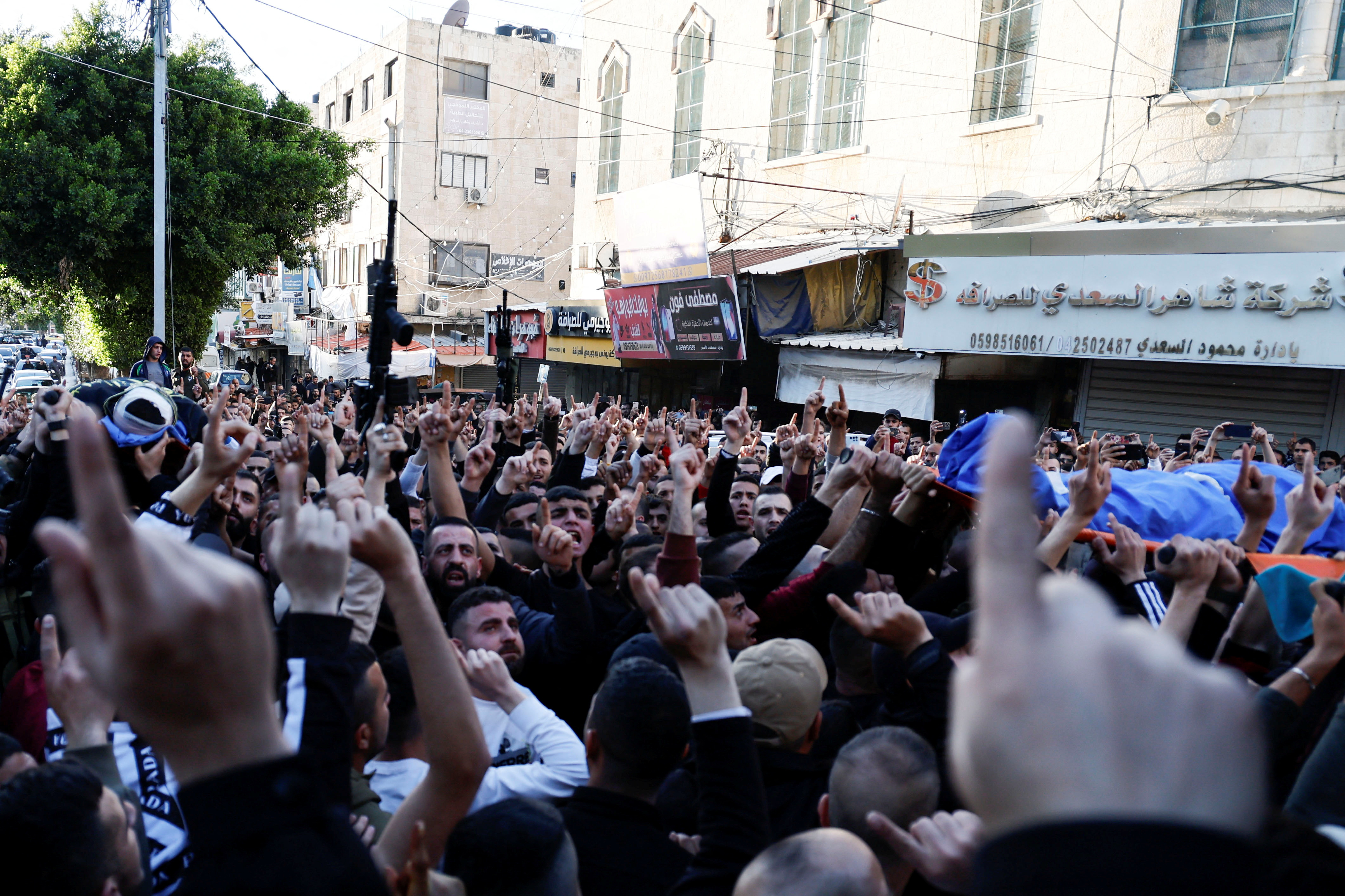 Mourners carry the bodies of Palestinians who were killed during a raid by undercover Israeli forces in Jenin