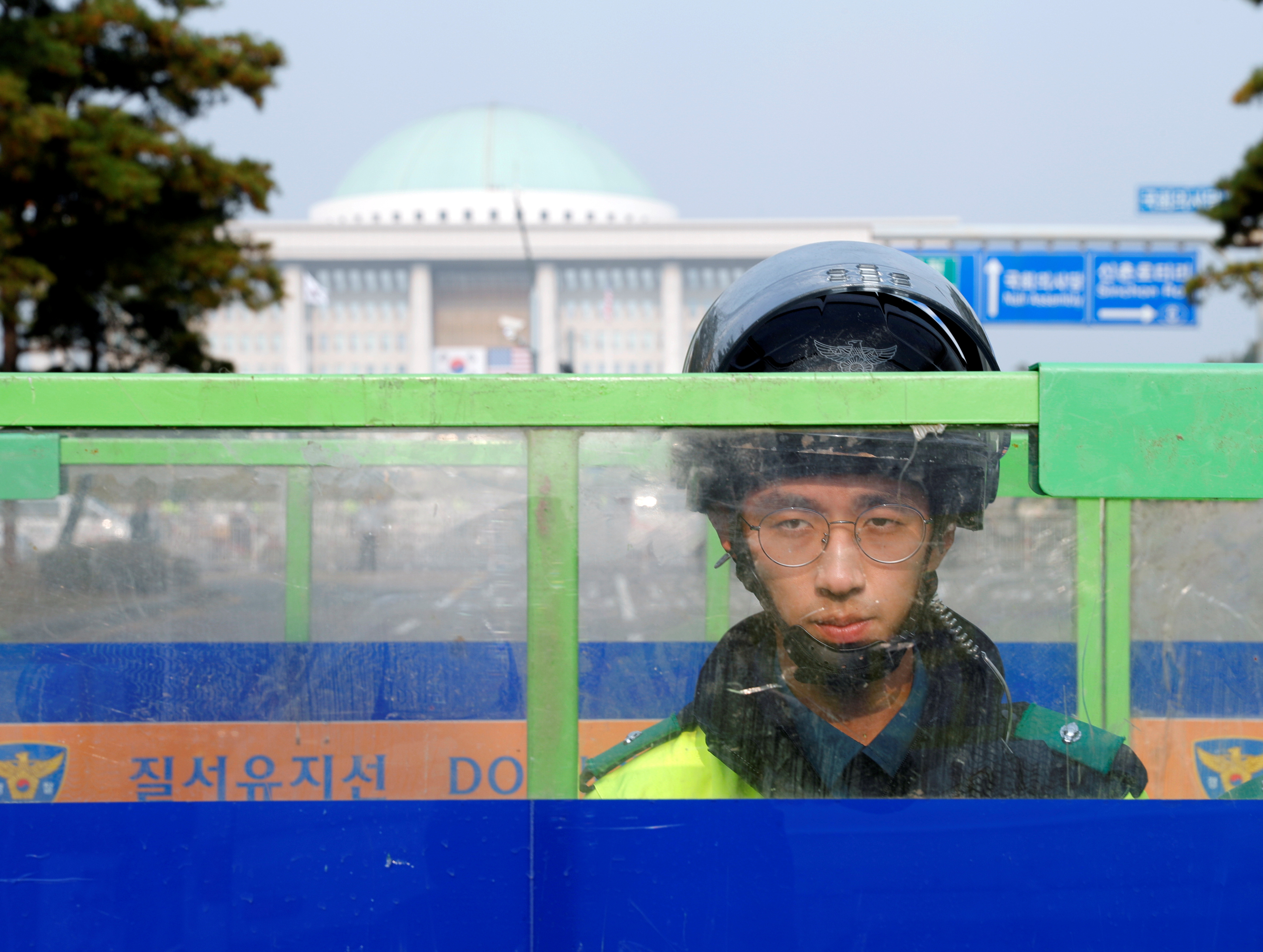 South Korean police officer stands guard in front of National Assembly