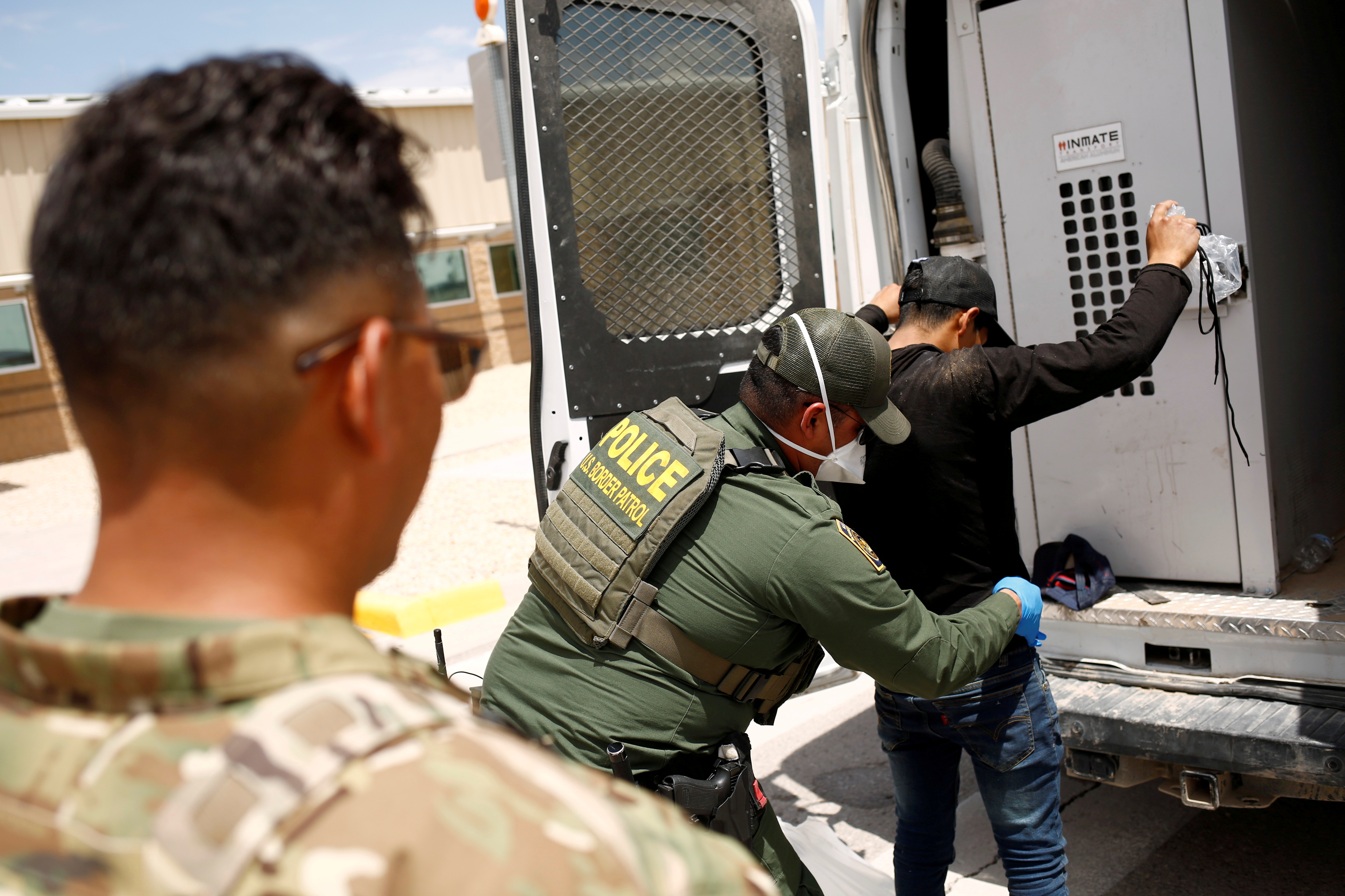A member of the Border Patrol's Search, Trauma, and Rescue Unit (BORSTAR) observes a migrant from Central America who was detained by U.S. Customs and Border Protection (CBP) agents after crossing into the United States from Mexico, in Dona Ana County, New Mexico, U.S., July 15, 2021. REUTERS/Jose Luis Gonzalez