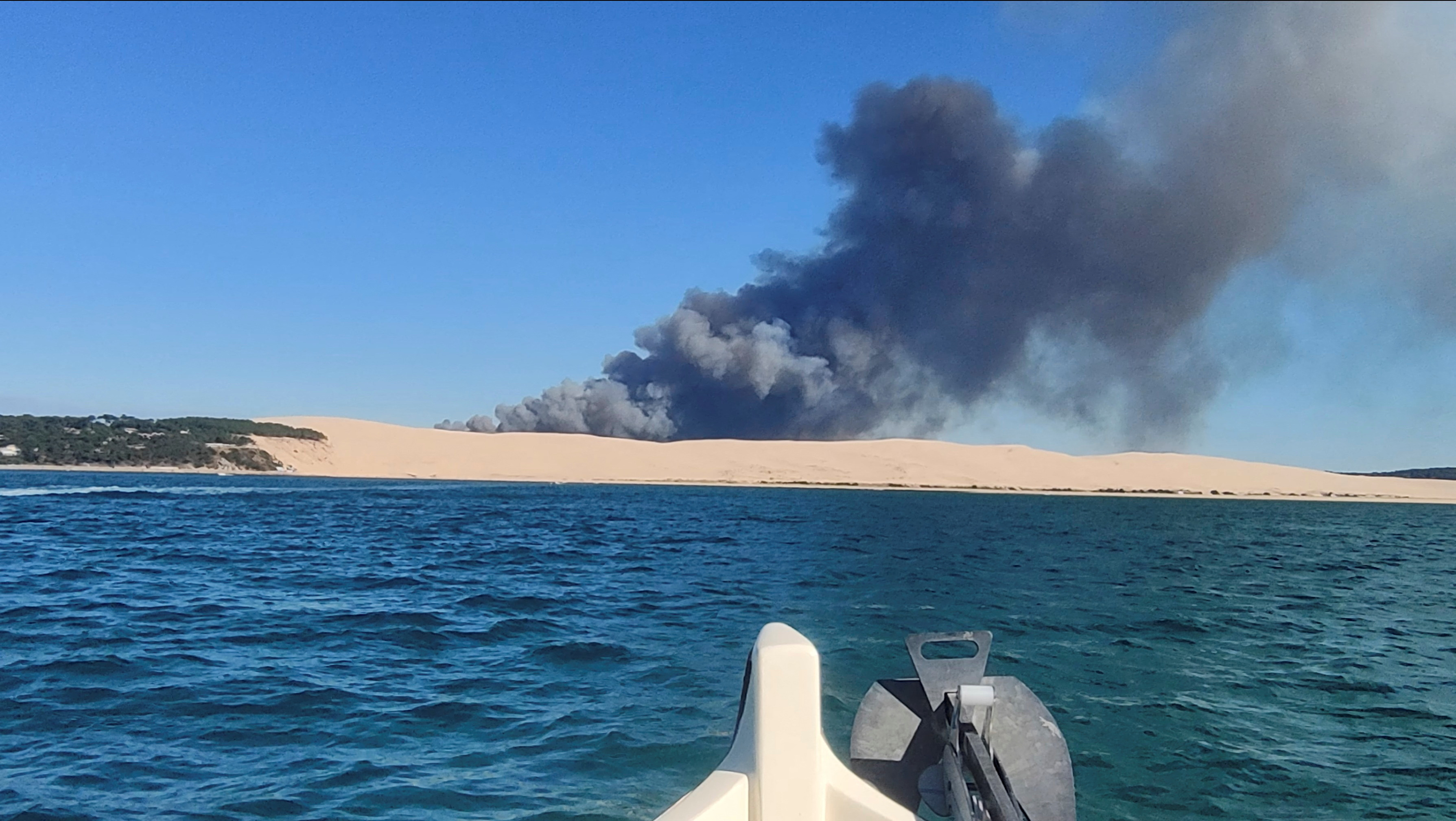 A general view shows smoke rising from the Gironde forest fires as seen from Dune de Pilat, Arcachon Bay
