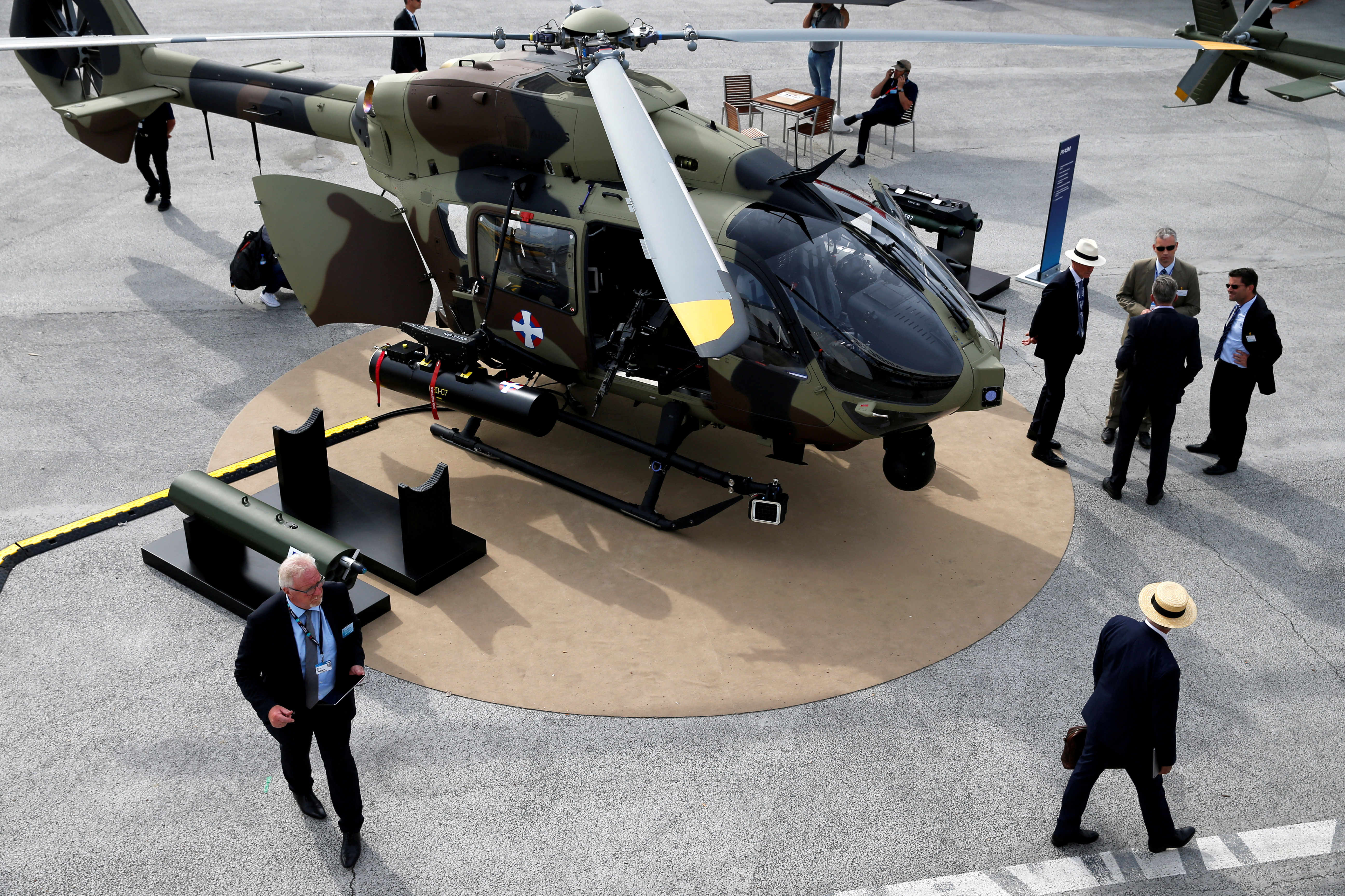 Visitors look at an Airbus Helicopter H145 on static display during the 53rd International Paris Air Show at Le Bourget Airport near Paris