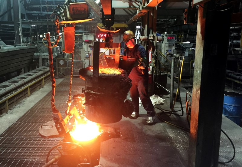 A worker at Bremen Castings, preparing to pour molten iron on the edge of the foundry's production line in Bremen